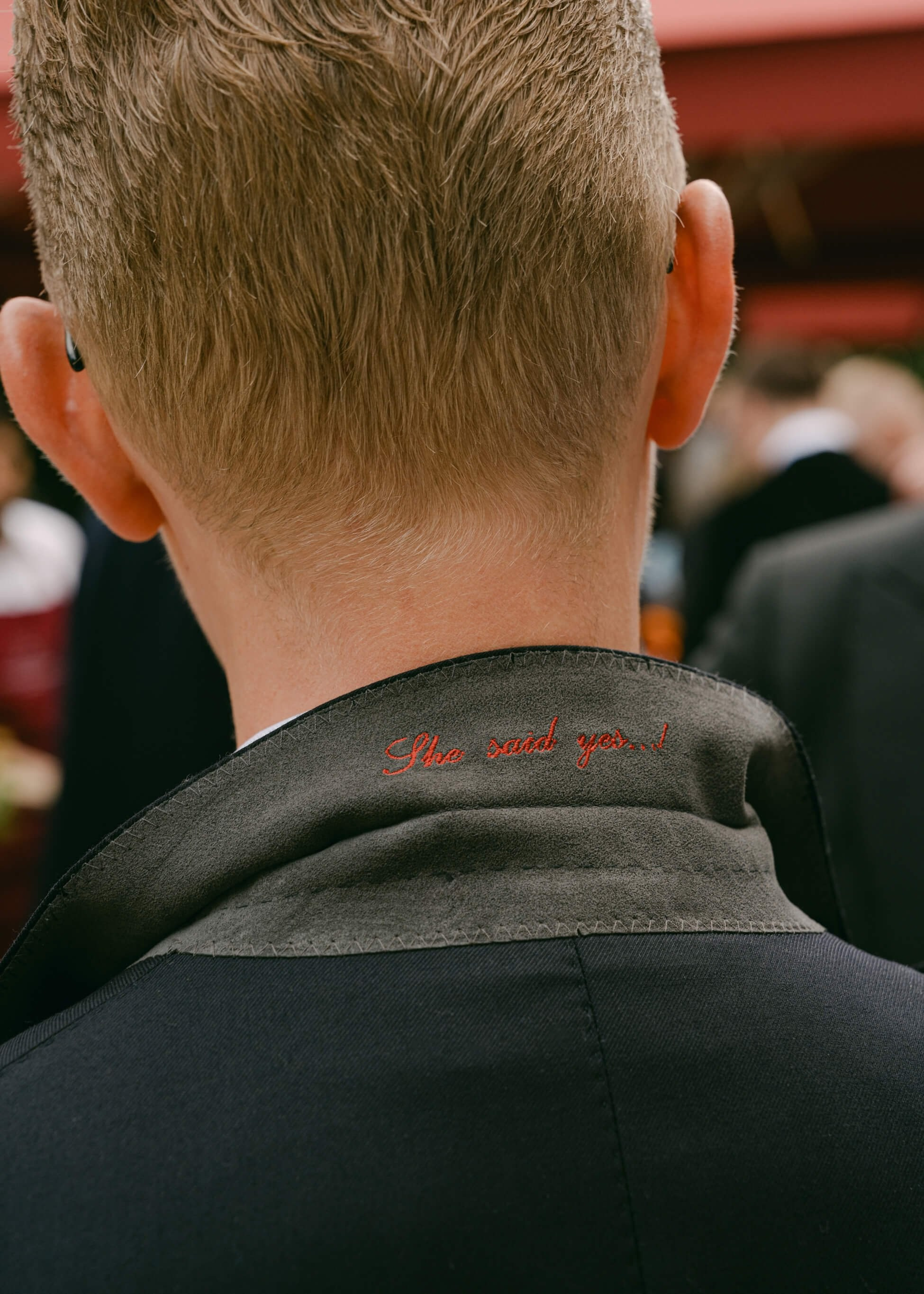 Groom's suit detail saying She said yes
