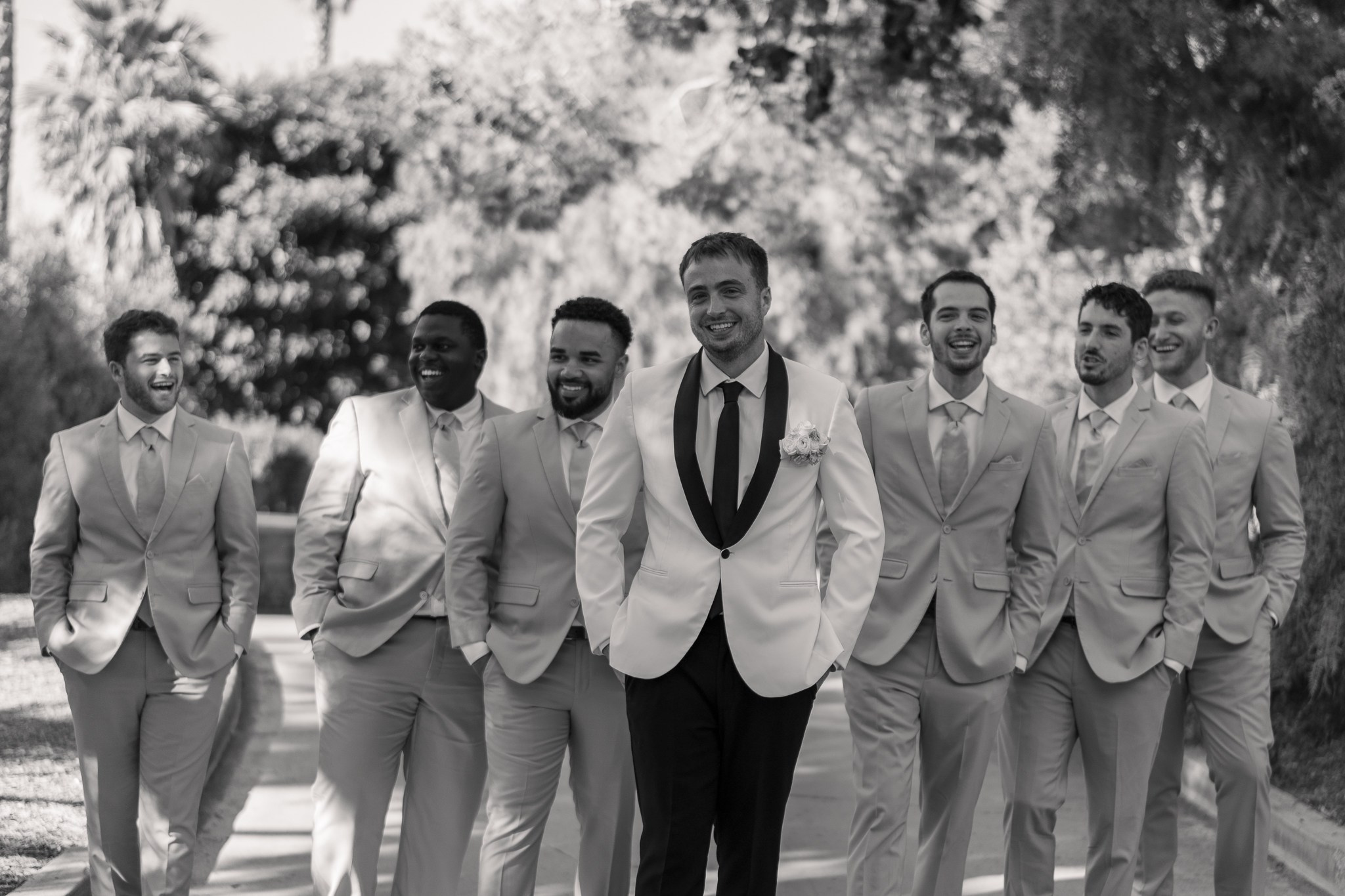 groom and groomsmen wearing different suits