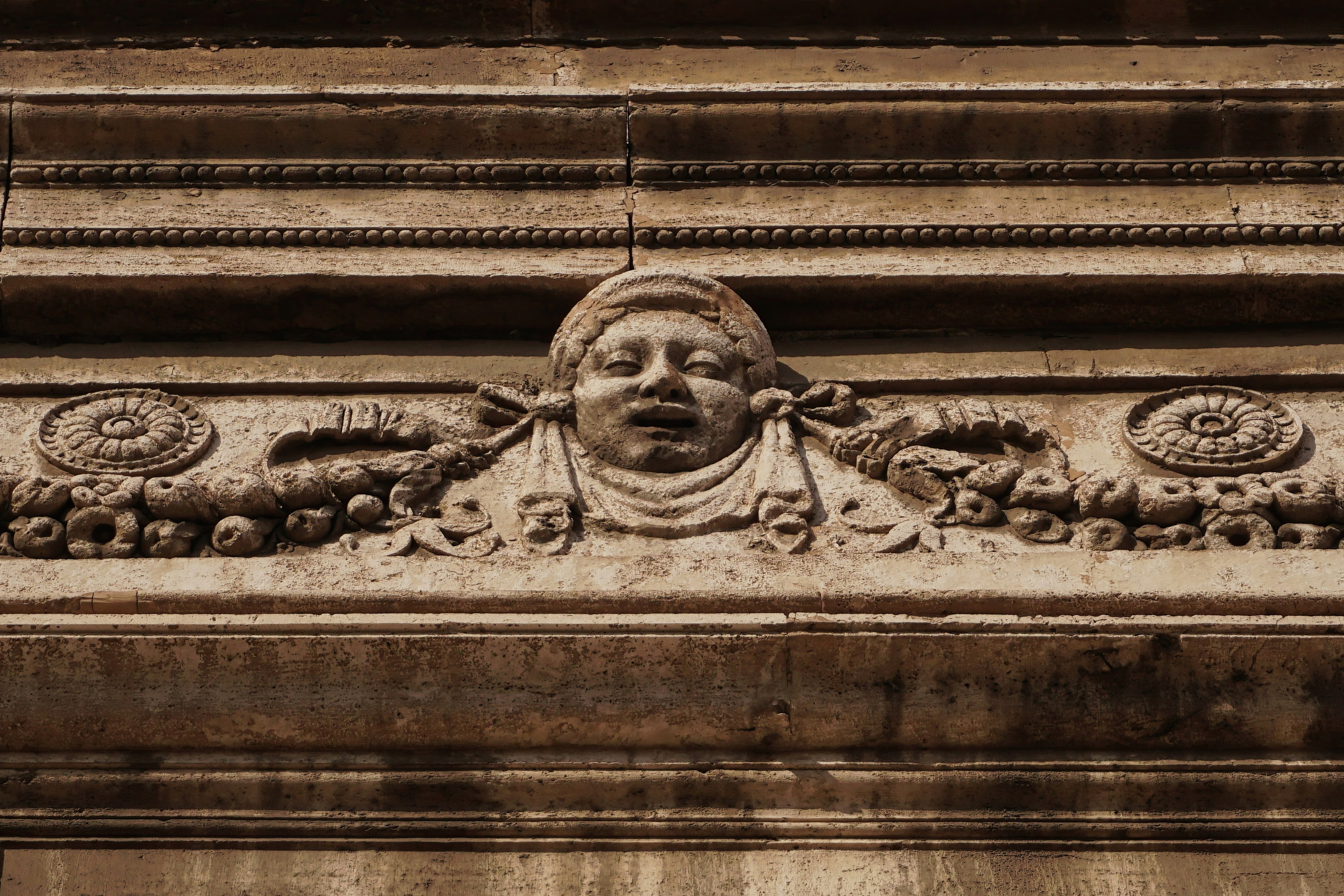 Photography of Italy – Bas-relief on a building facade in Trastevere, Rome, photographed as part of a photography book about Rome.