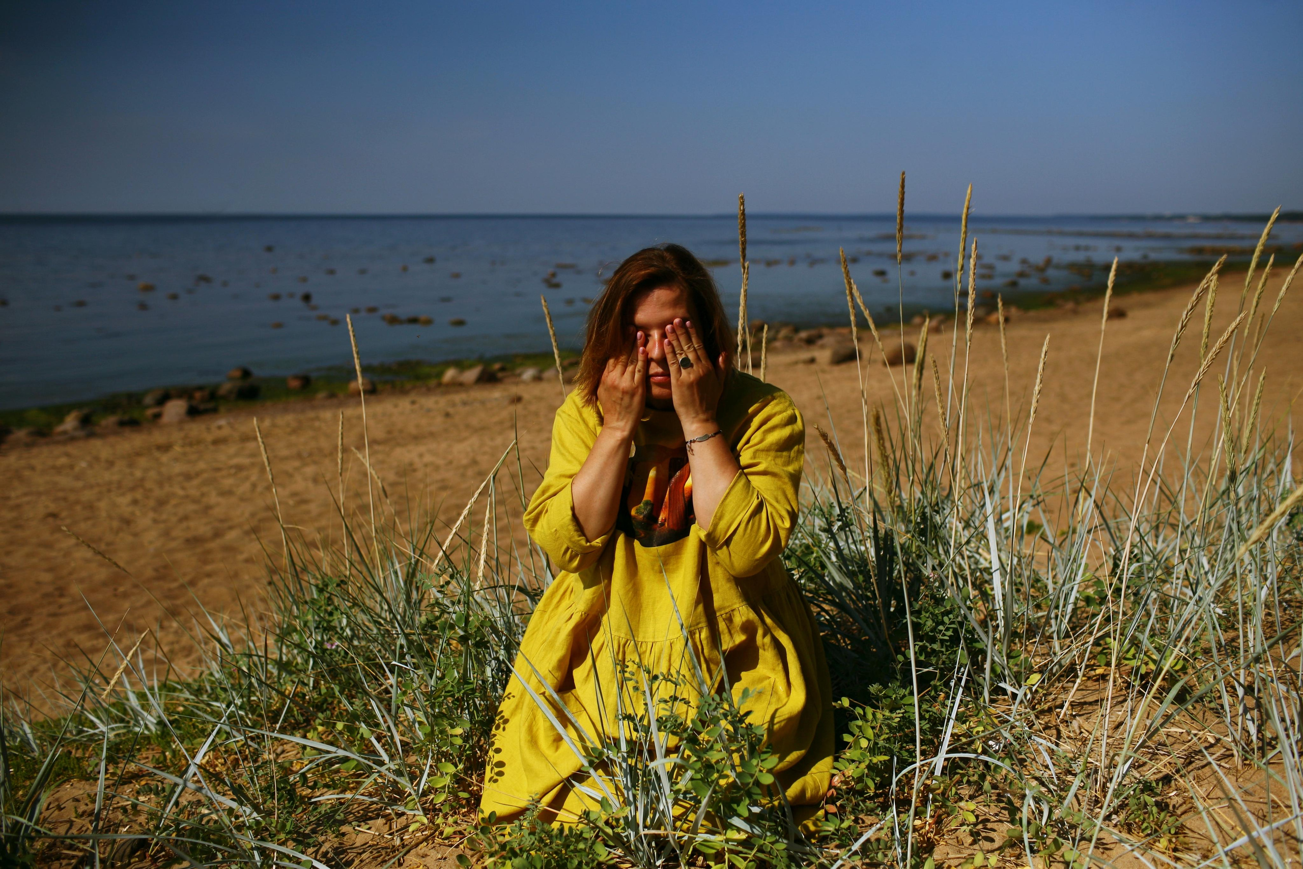 Anna, by herself. Stones and sand. Victoria Dini. Art photography in London / Folkestone, UK