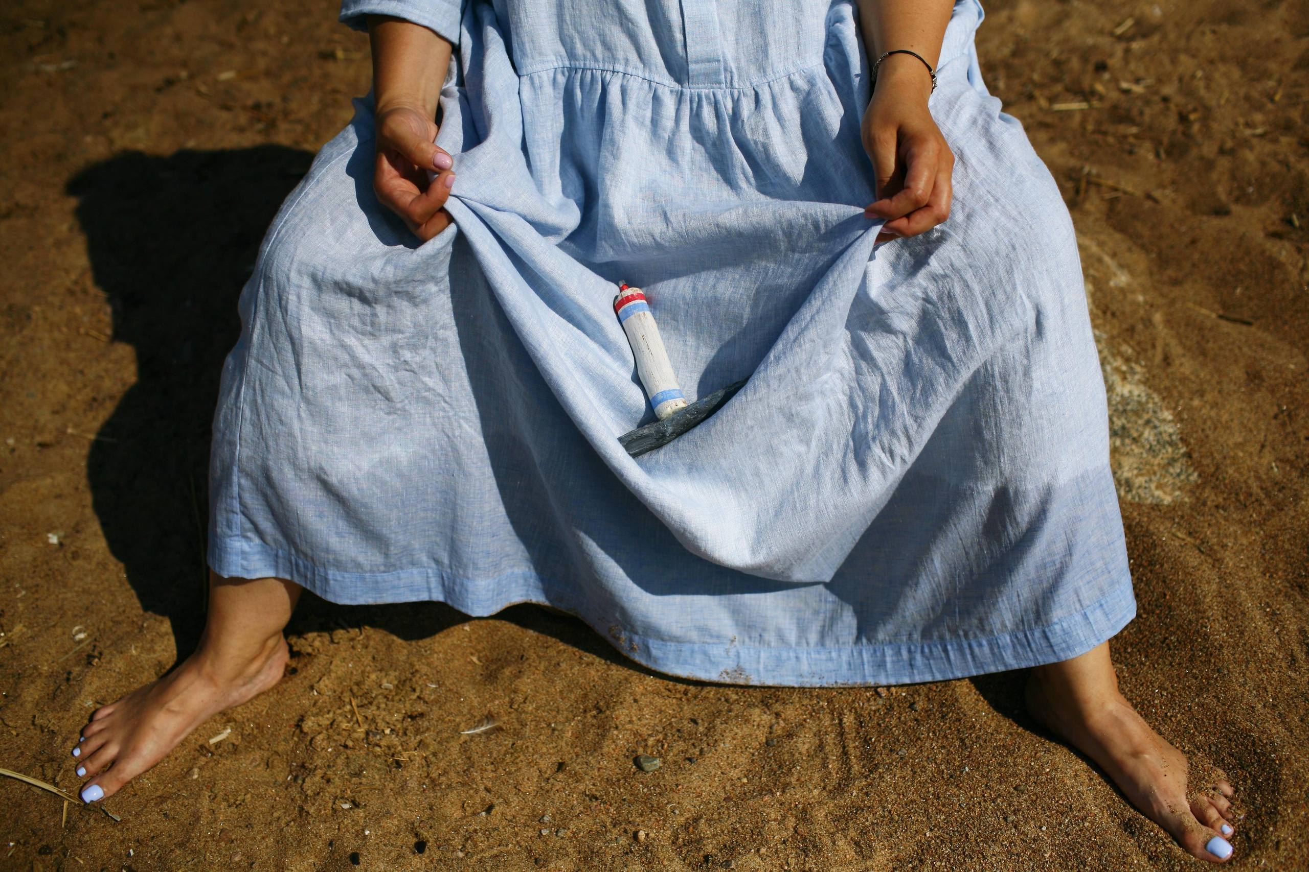 Anna, by herself. Stones and sand. Victoria Dini. Art photography in London / Folkestone, UK