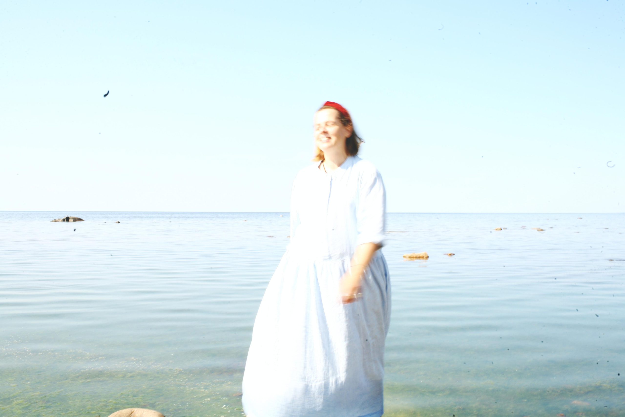 Anna, by herself. Stones and sand. Victoria Dini. Art photography in London / Folkestone, UK