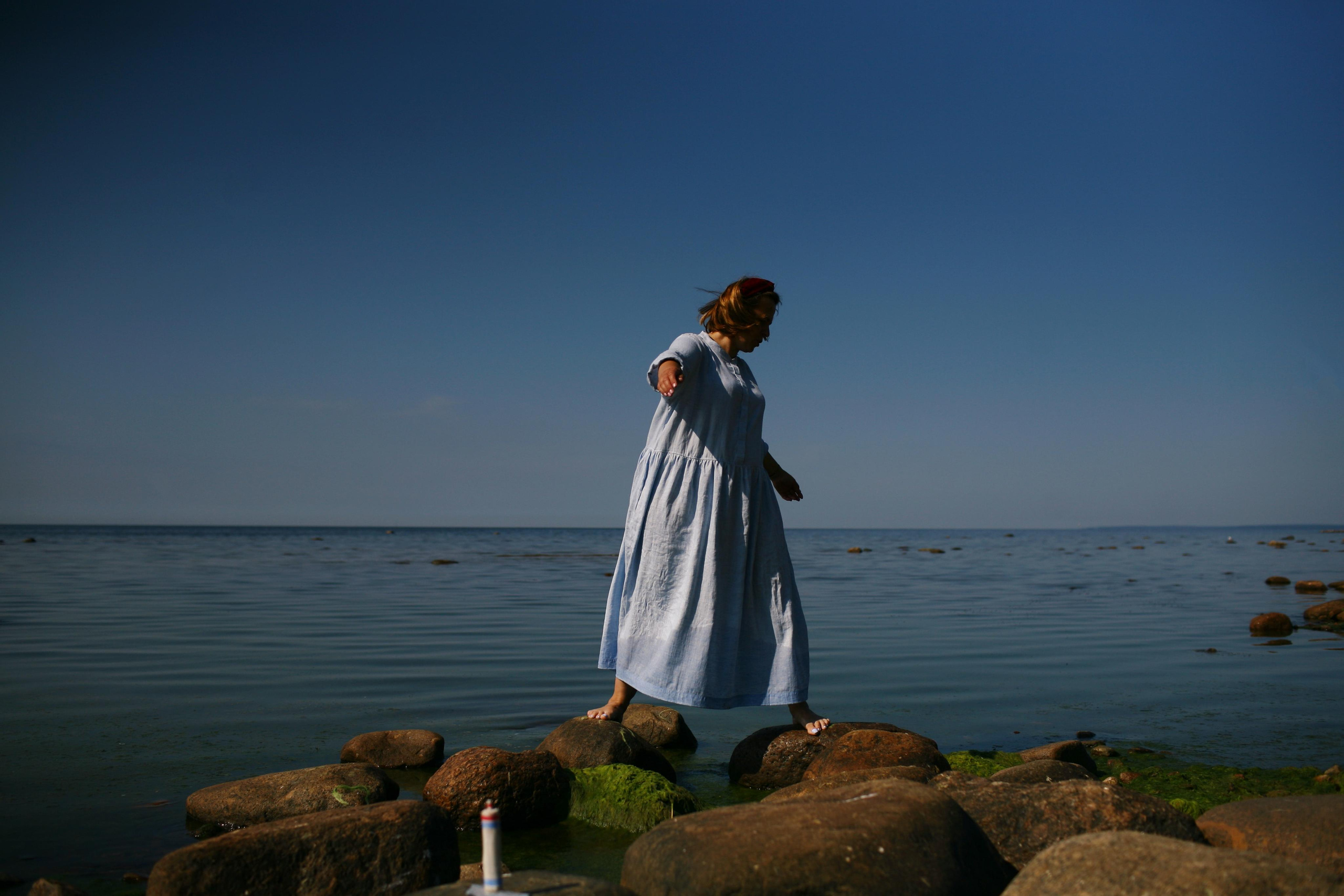 Anna, by herself. Stones and sand. Victoria Dini. Art photography in London / Folkestone, UK