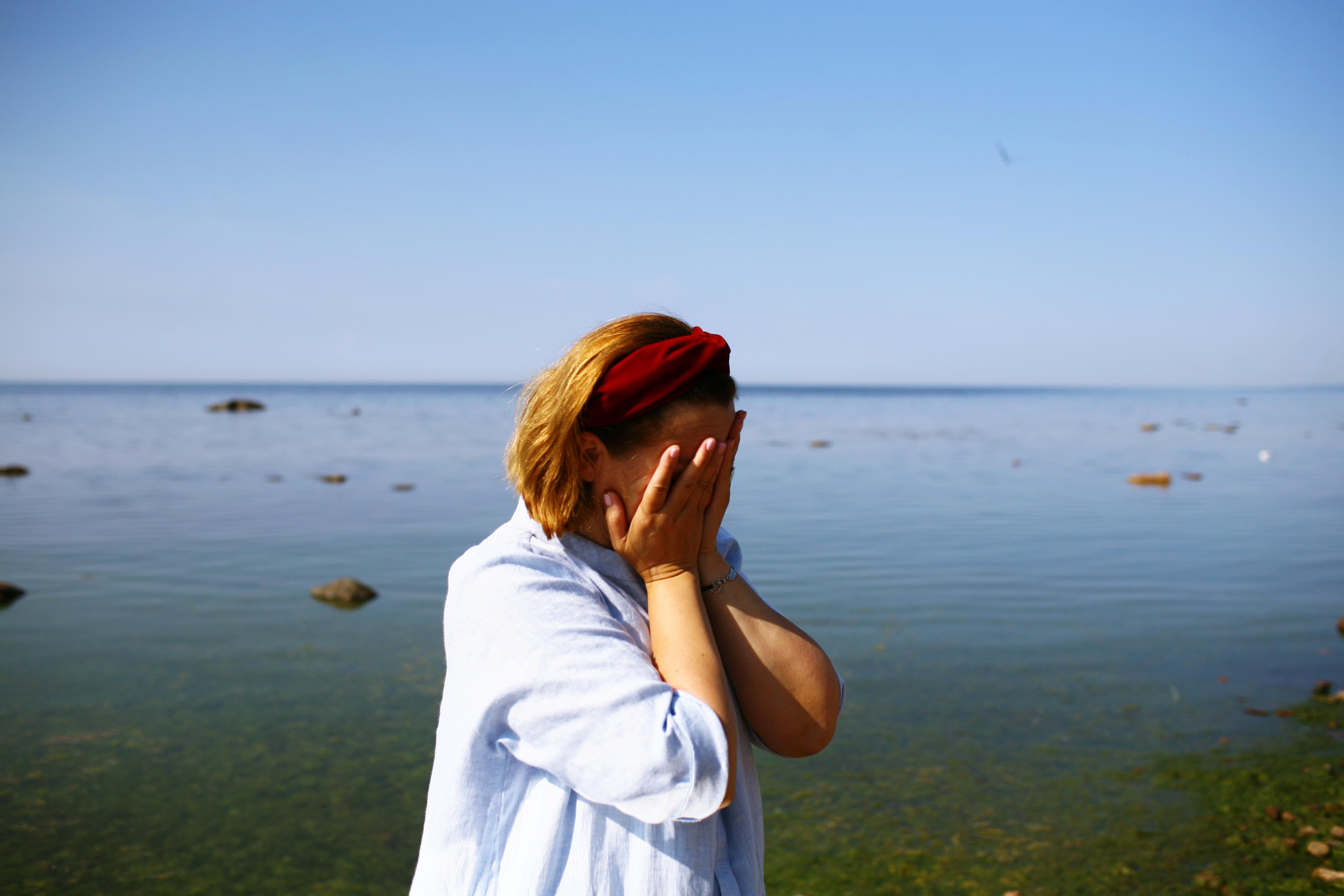 Anna, by herself. Stones and sand. Victoria Dini. Art photography in London / Folkestone, UK