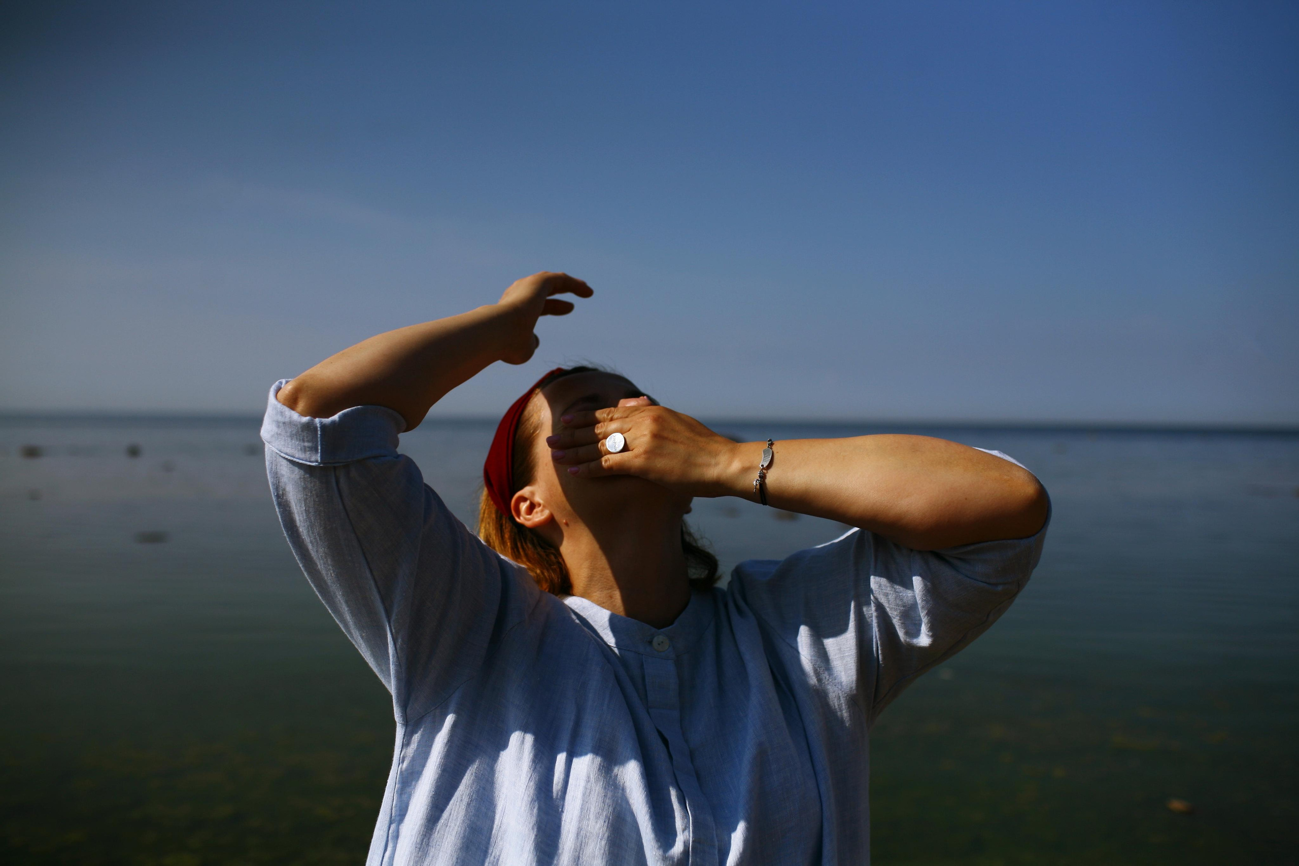 Anna, by herself. Stones and sand. Victoria Dini. Art photography in London / Folkestone, UK