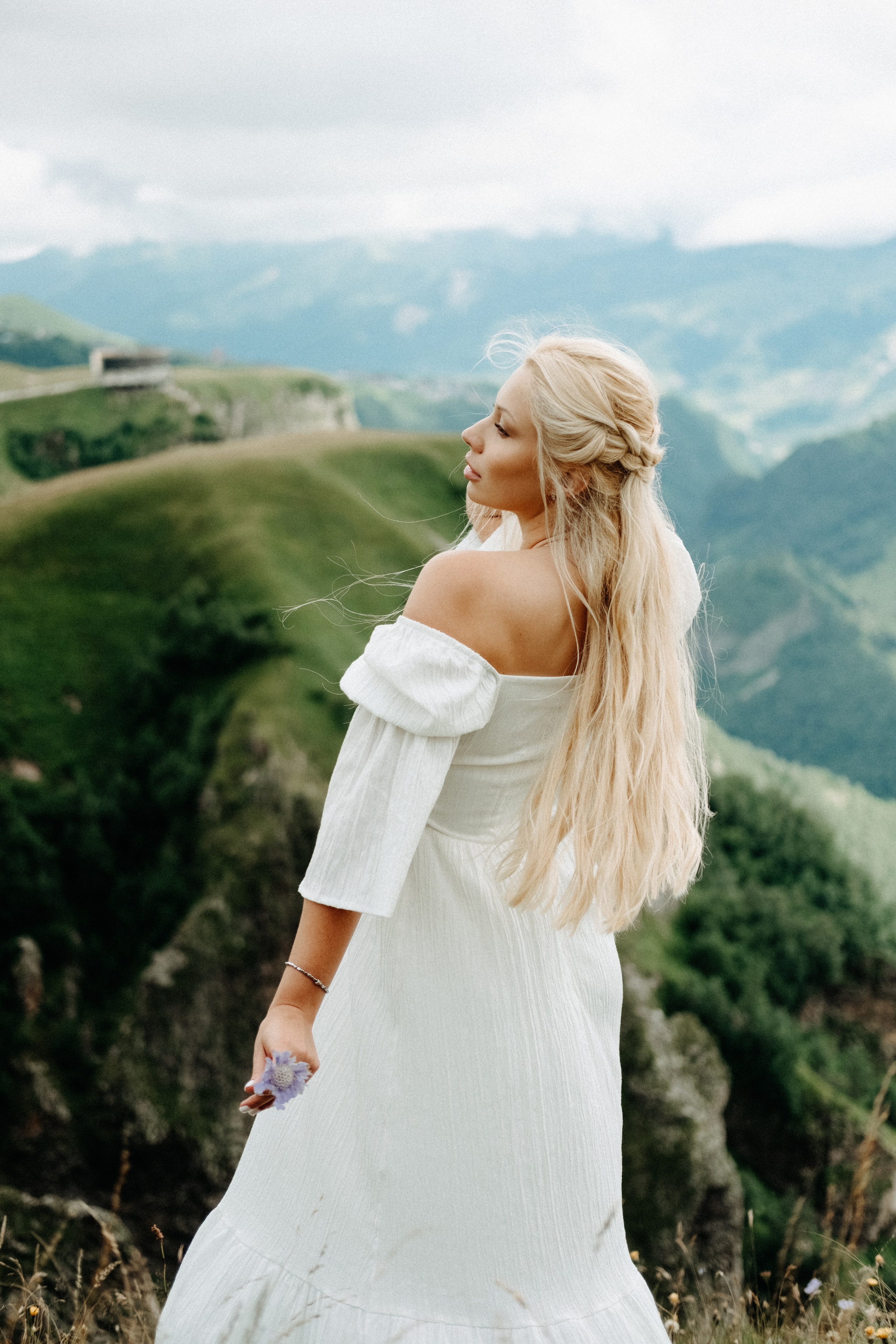 Woman looking at Caucasus mountains from behind