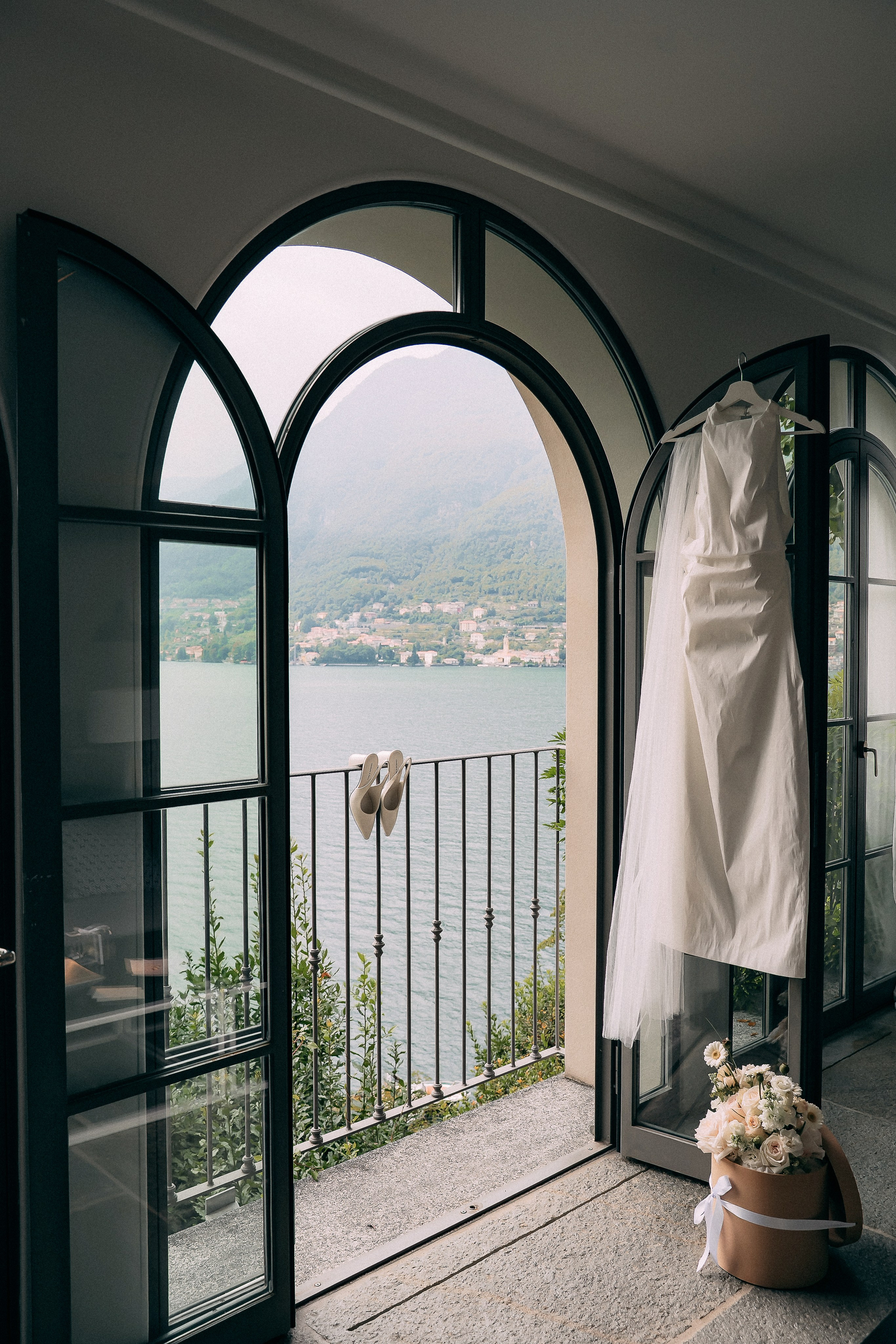 Wedding gown displayed in an arched doorway at Villa Lario, overlooking Lake Como, Italy