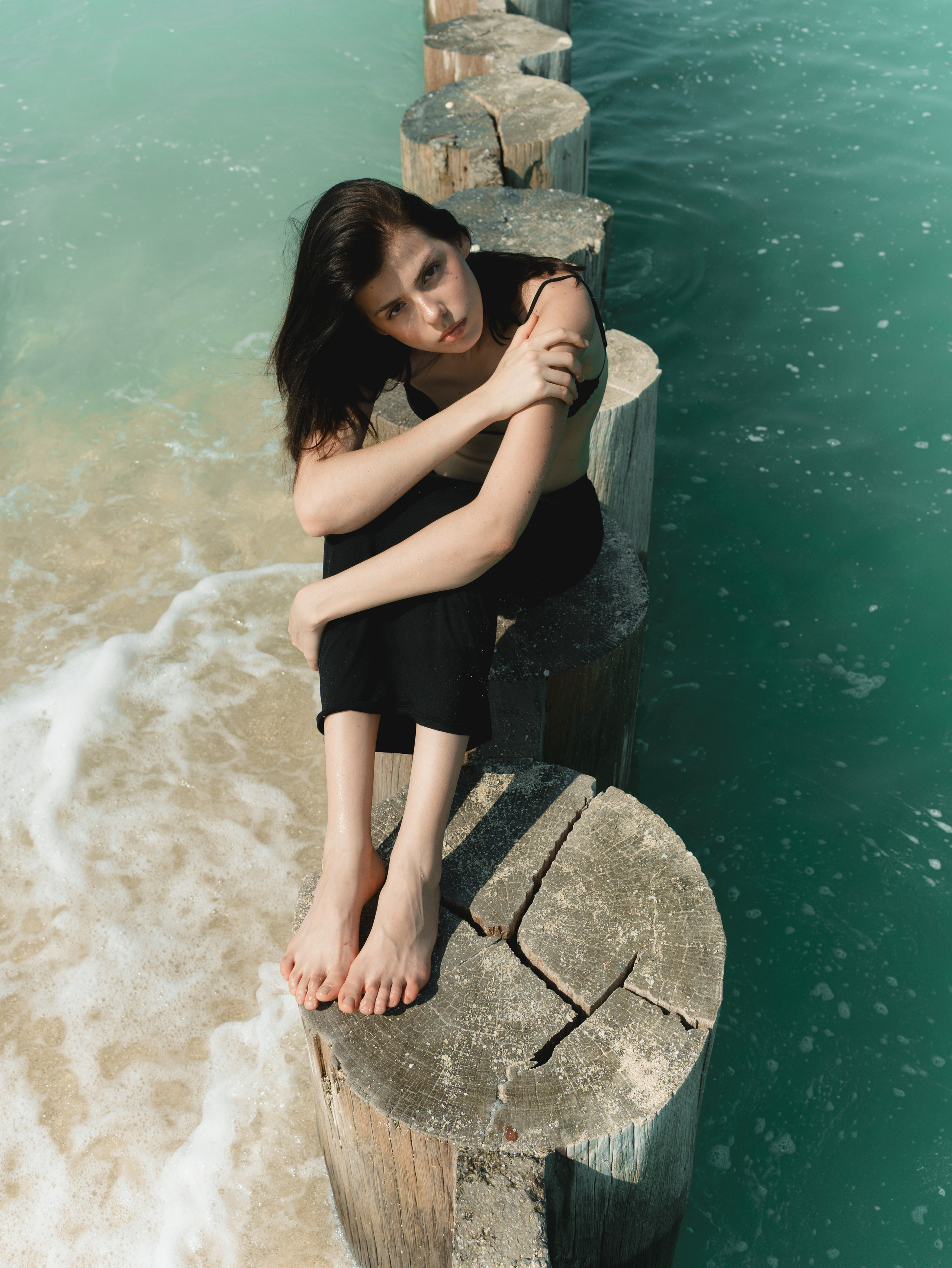 Fashion portrait series on the beach in minimalistic swimwear look. Alisha Geva | Contemporary fashion women’s portrait Dubai