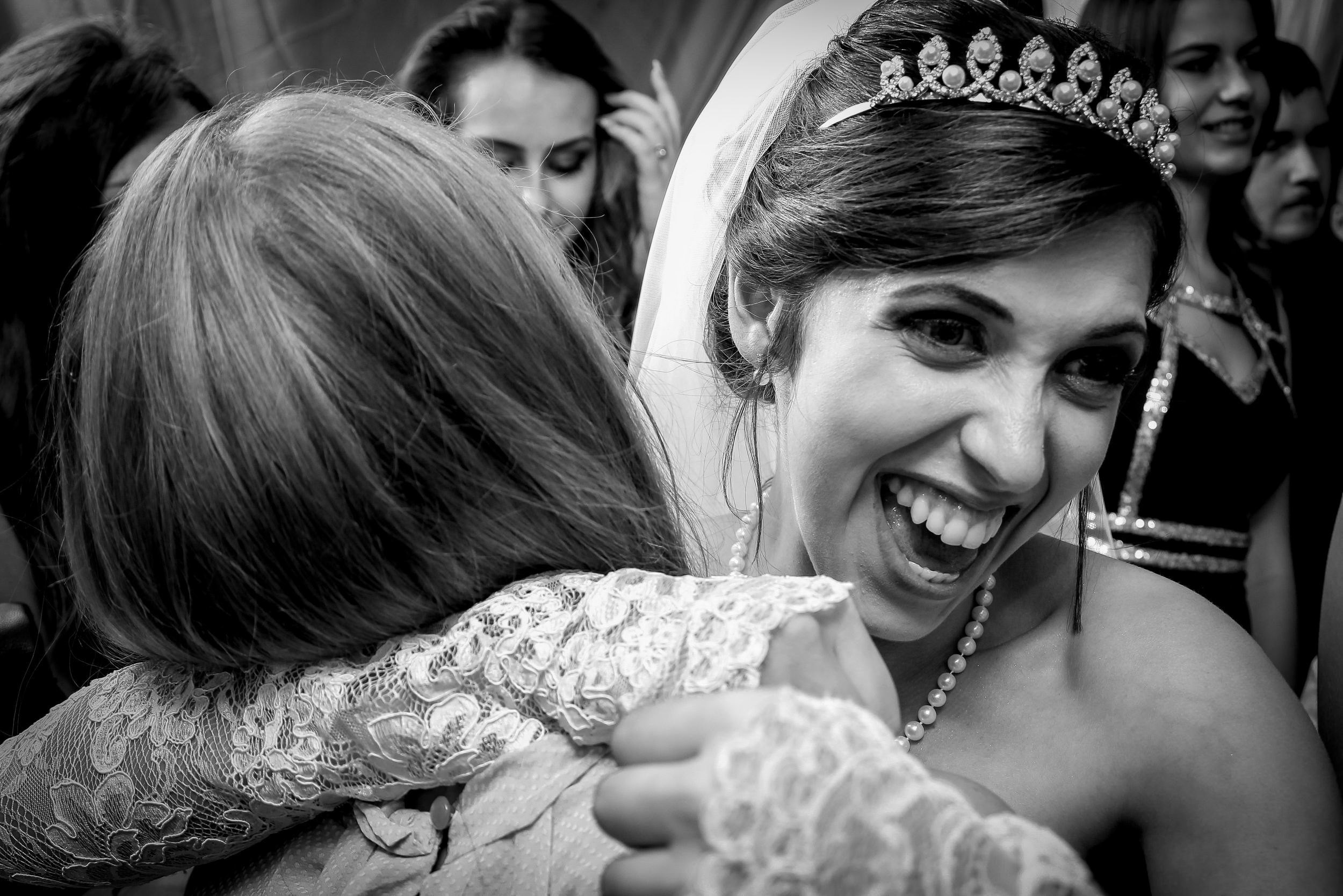 Joyful bride with hugging her friend during a wedding celebration in Israel