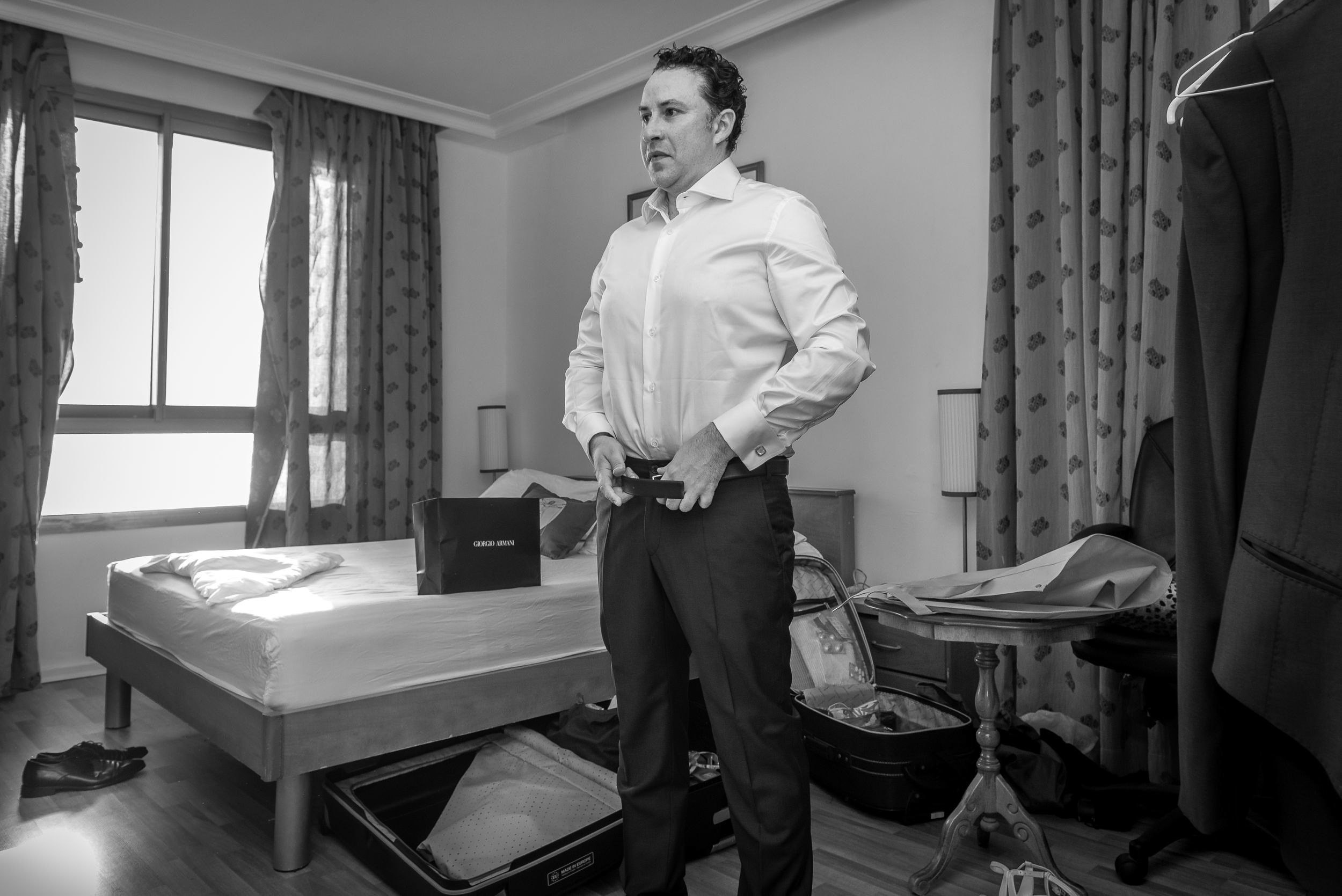 Groom Michael putting on his wedding suit during preparation at the Leonardo Hotel in Haifa, Israel