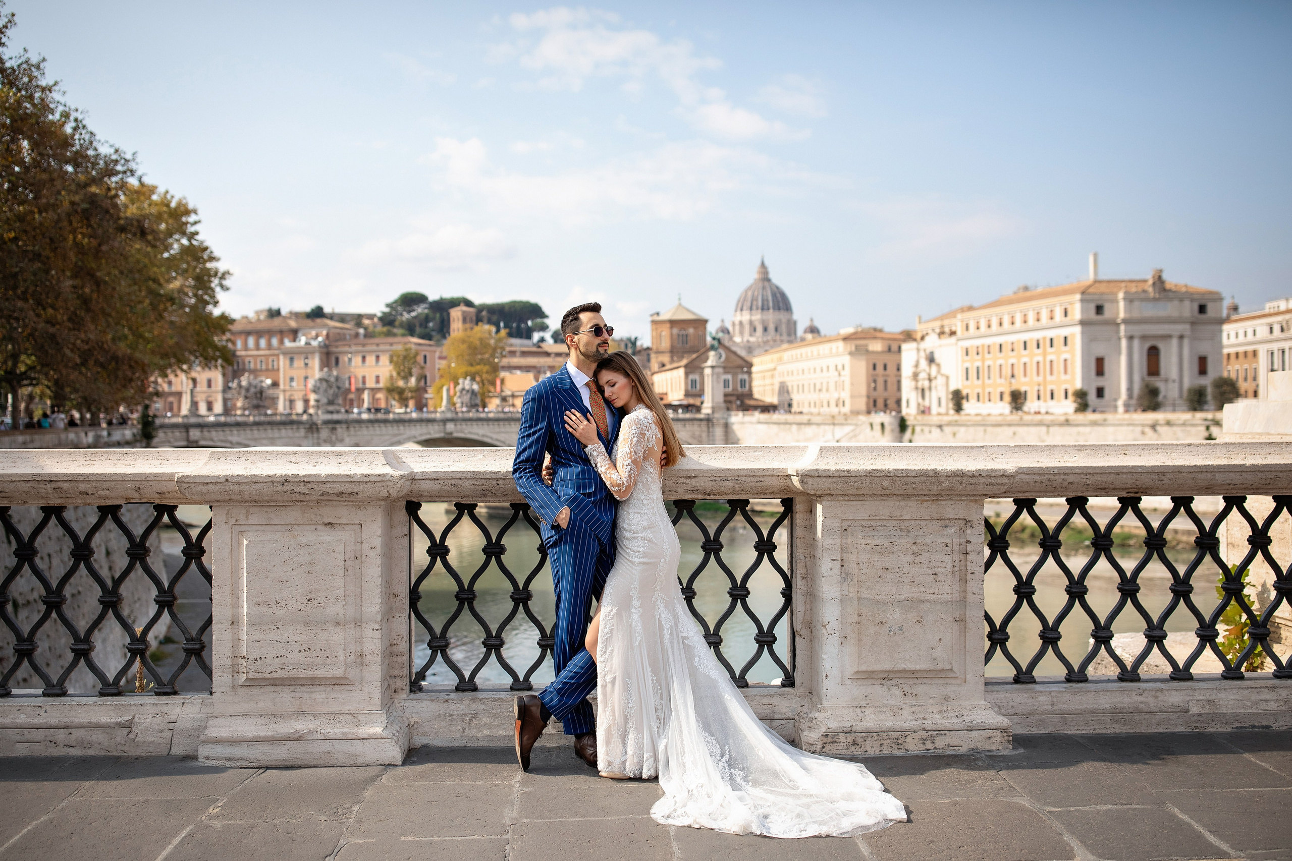 Bride and groom in wedding attire at Castel Sant'Angelo during a romantic photoshoot in Rome