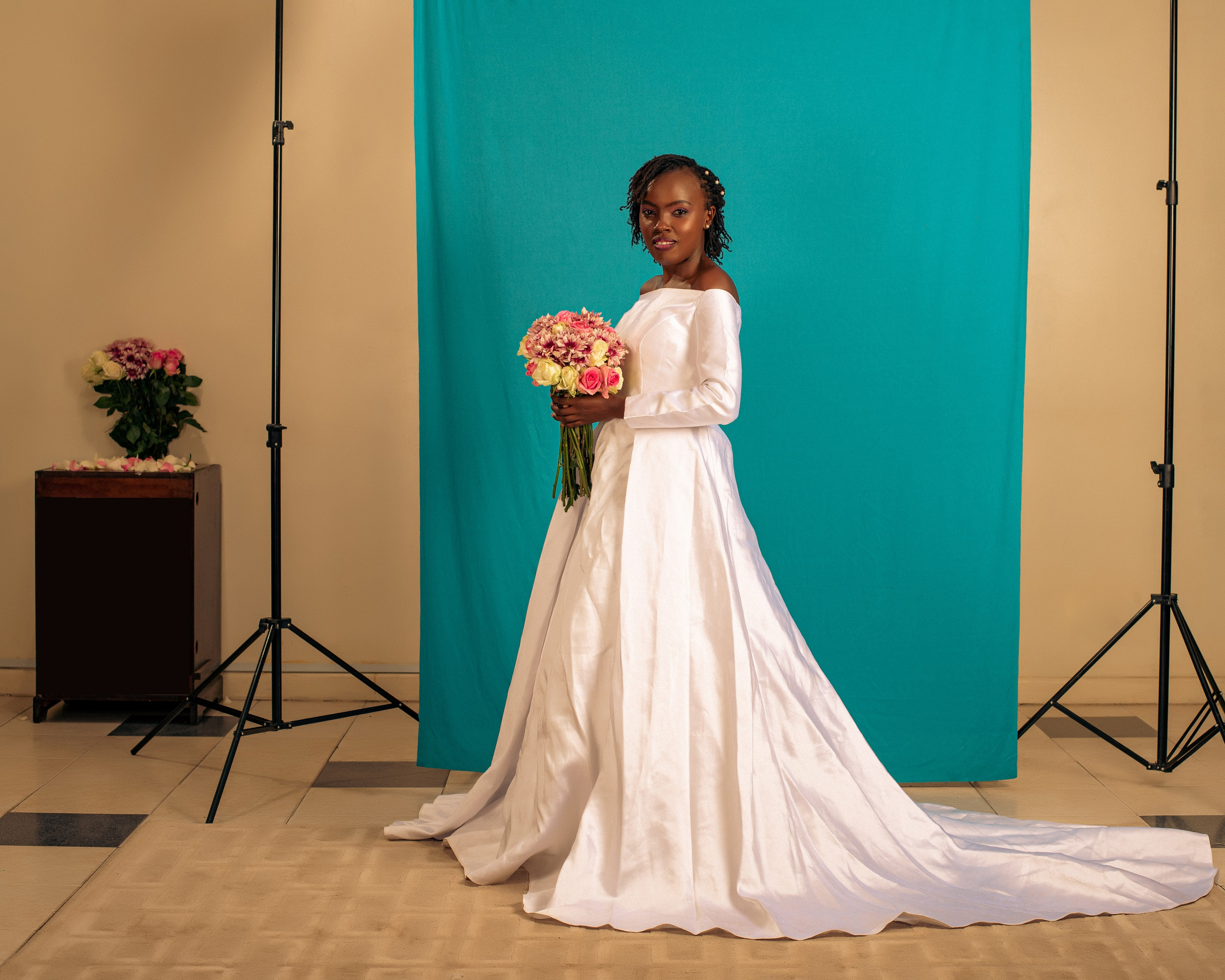 A studio portrait of a beautiful bride with a bouquet of flowers