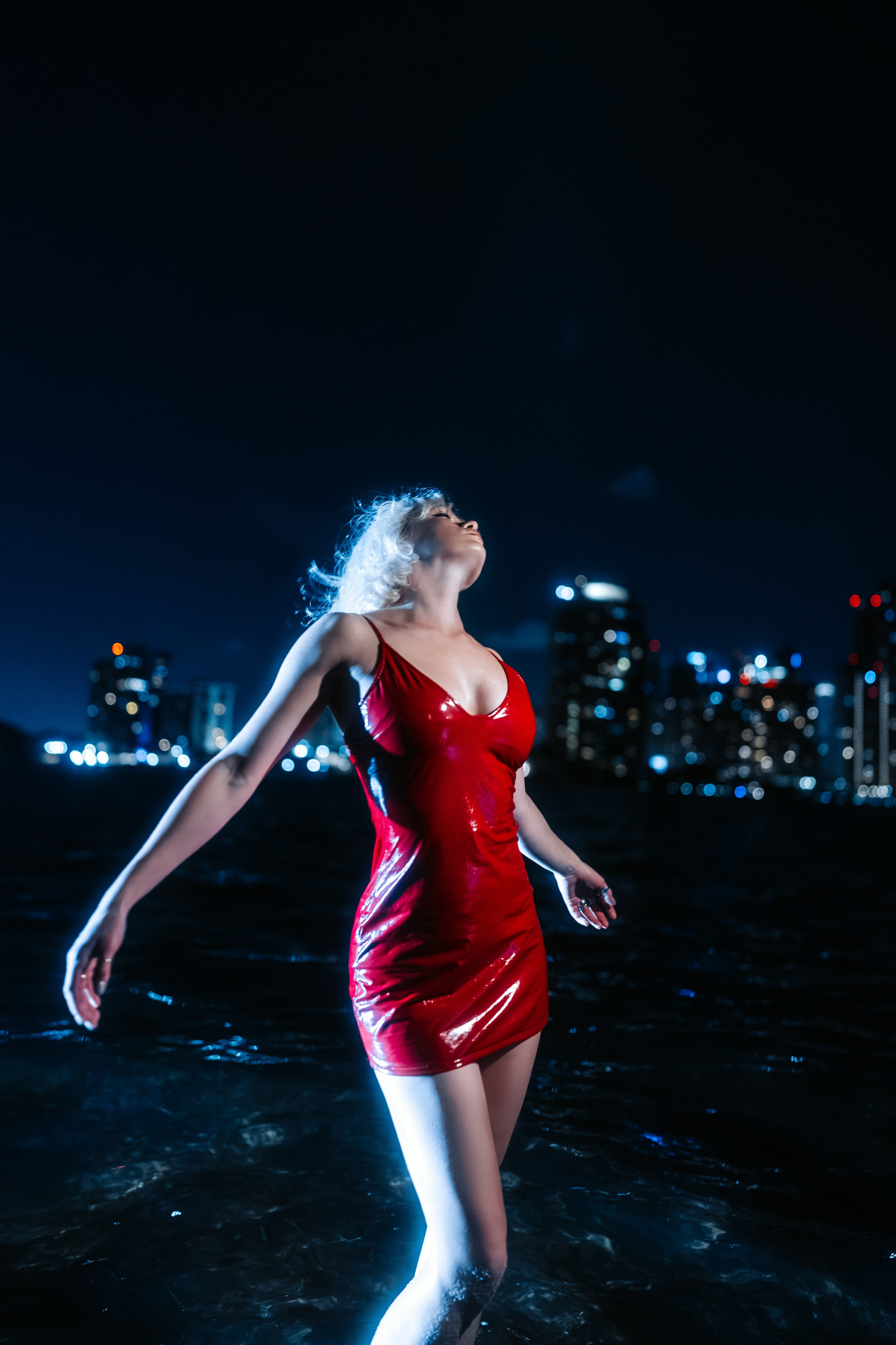 Portrait against downtown lights — the feeling of a big city and personal narrative.