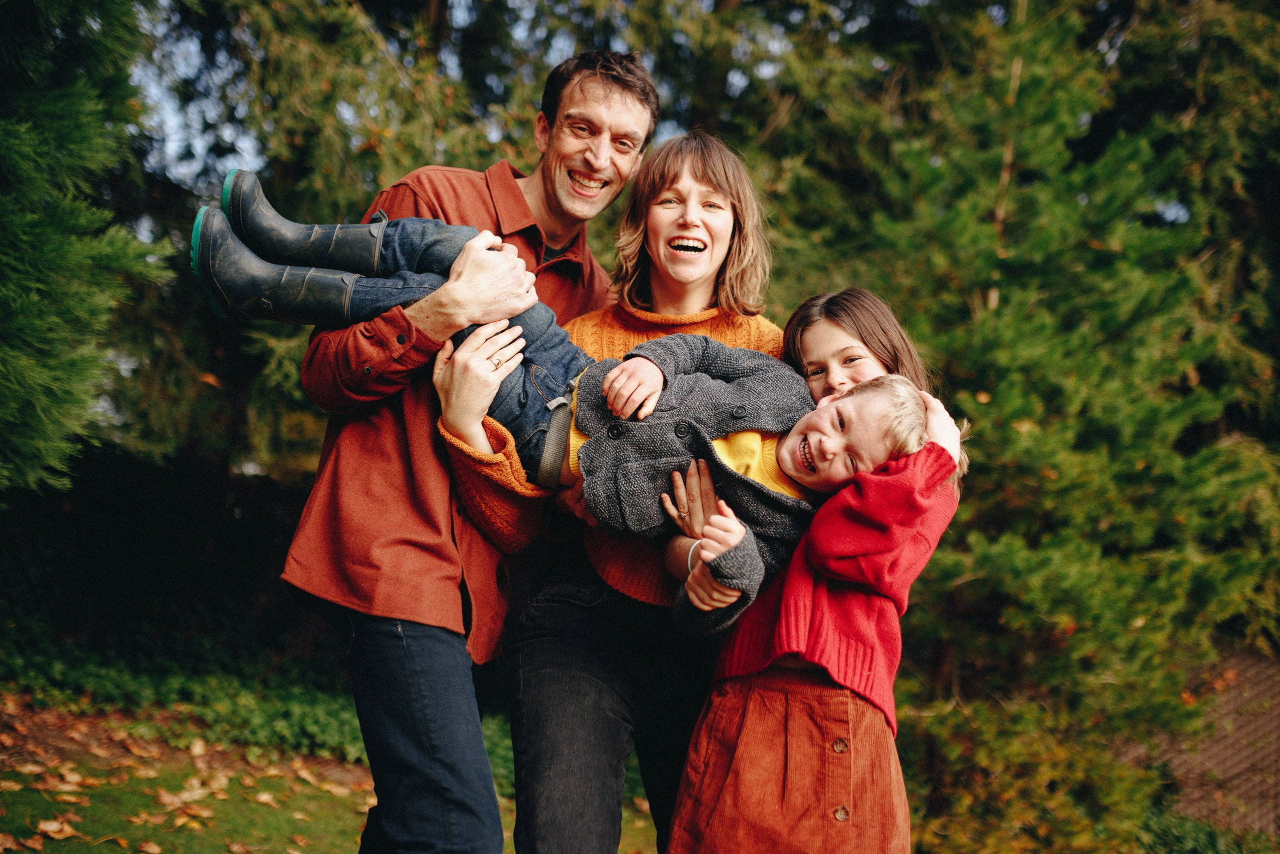 Family group hug outdoors, joyful candid moment