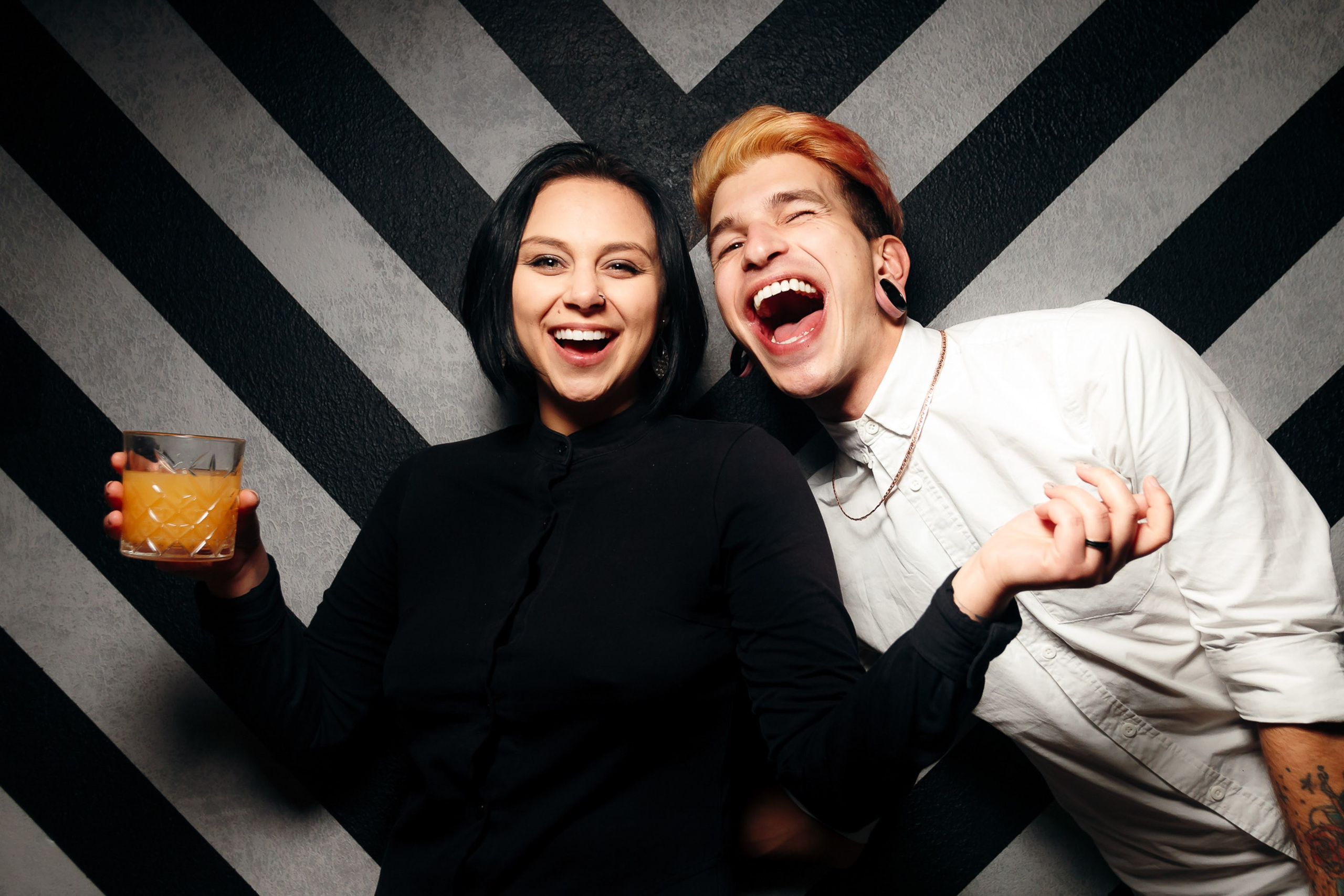 Two women laughing and posing at club, fun vibe
