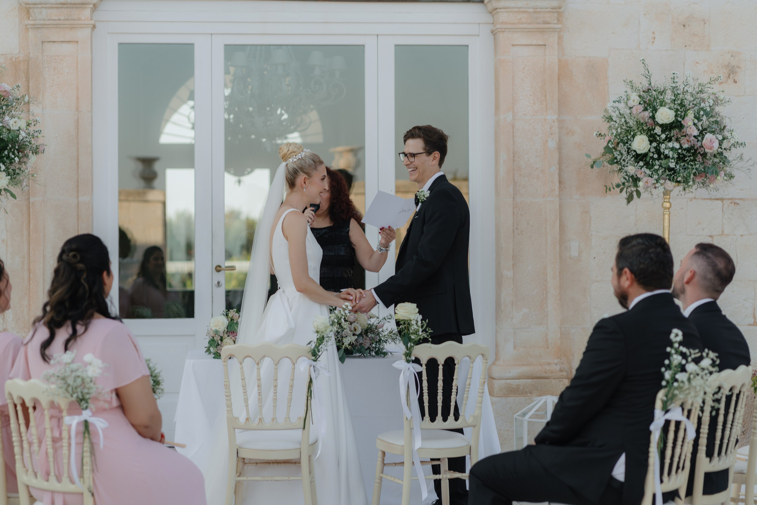 Bride and groom exchanging vows in courtyard of Masseria Traetta Exclusive