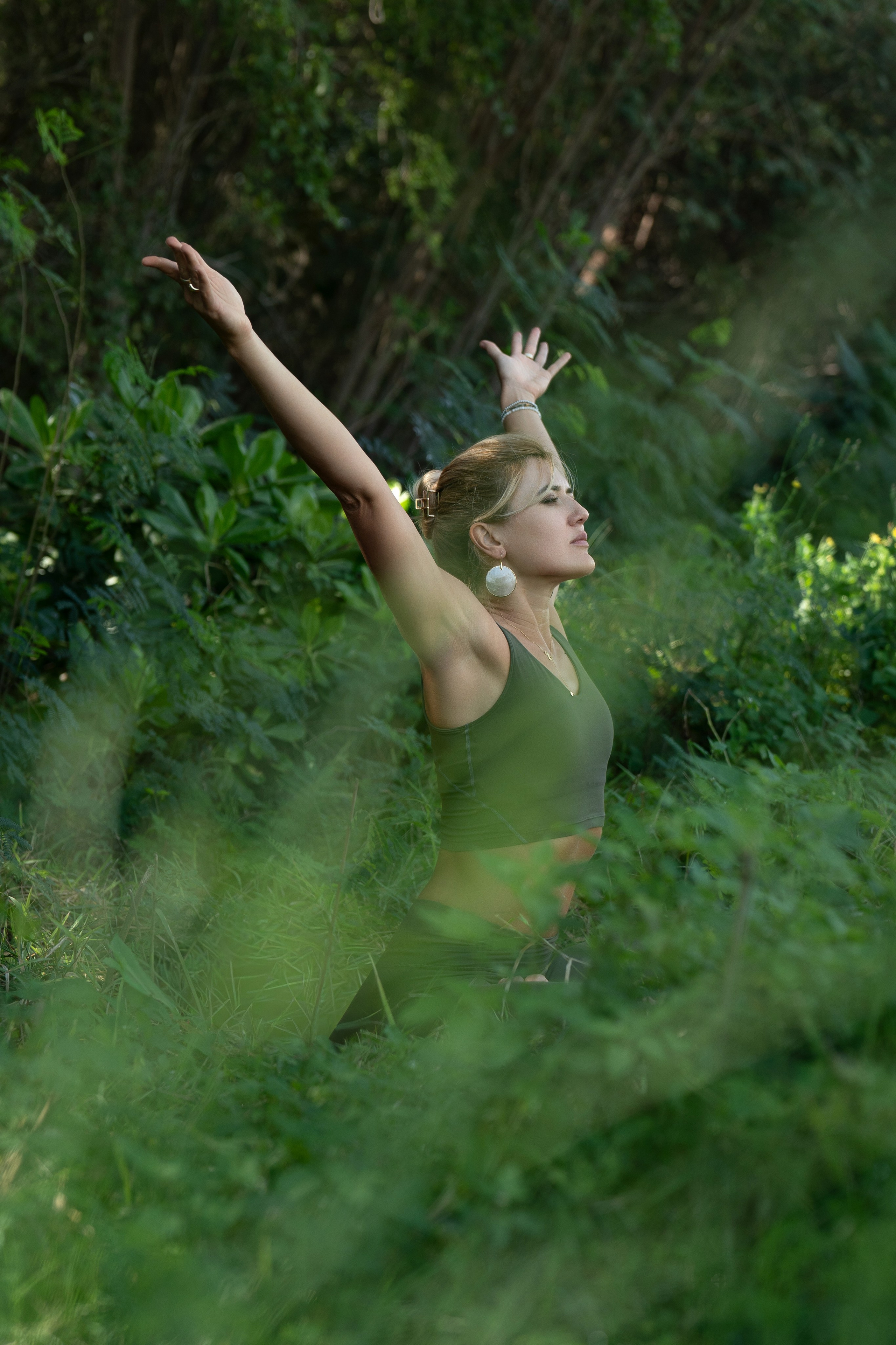 Woman doing yoga among trees