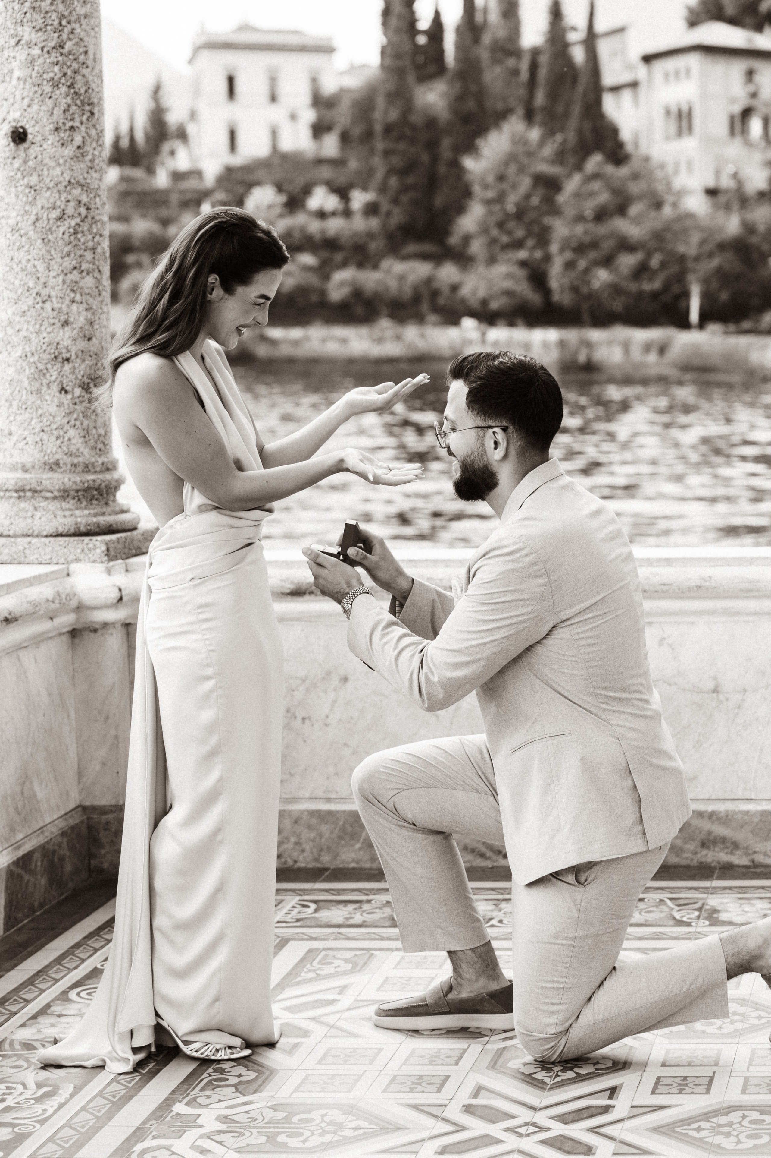 Romantic marriage proposal with a man kneeling on one knee on Lake Como at  Villa Monastero in Varenna
