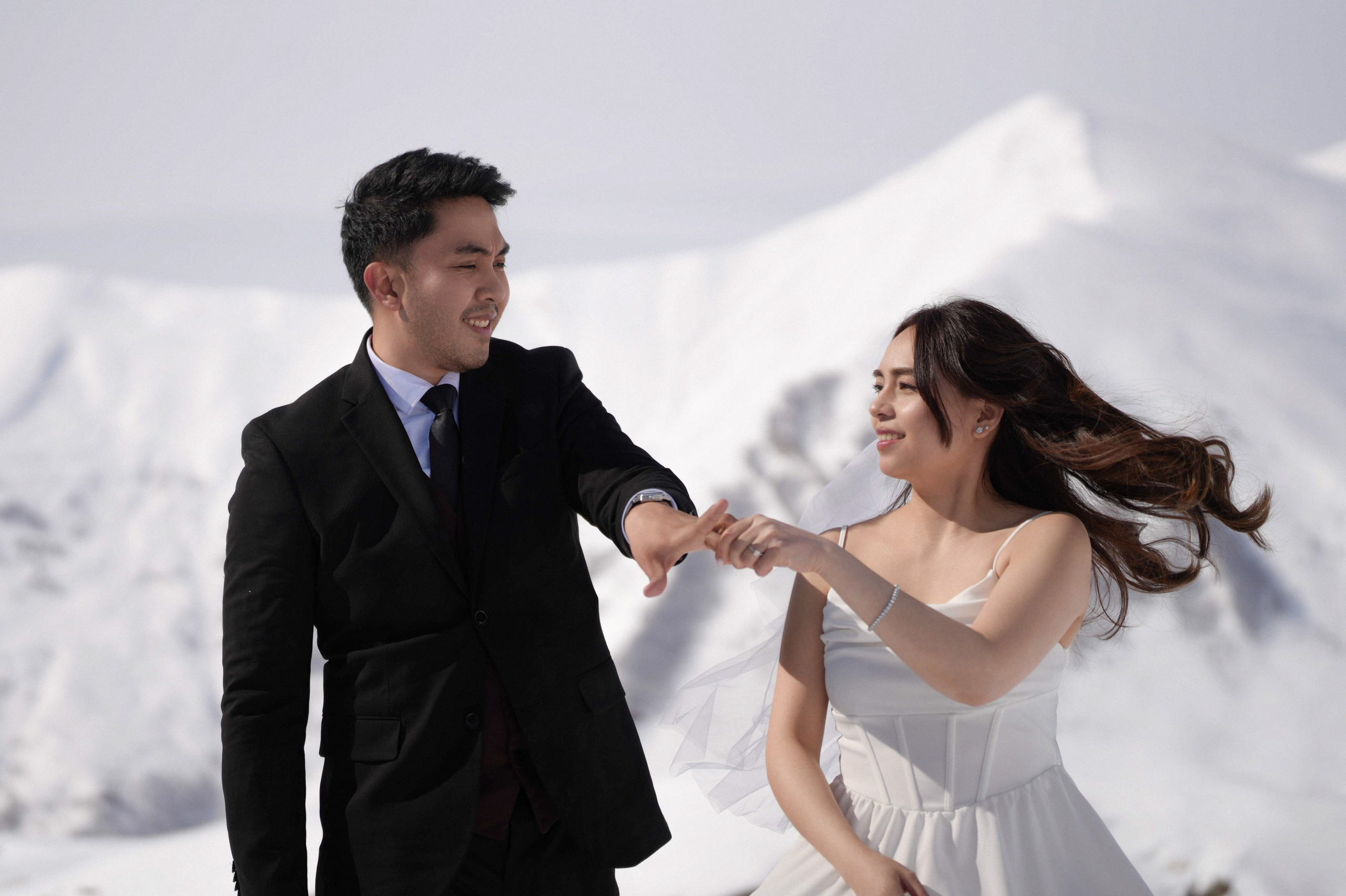 Bride and groom dancing at the top of Gudauri with panoramic view