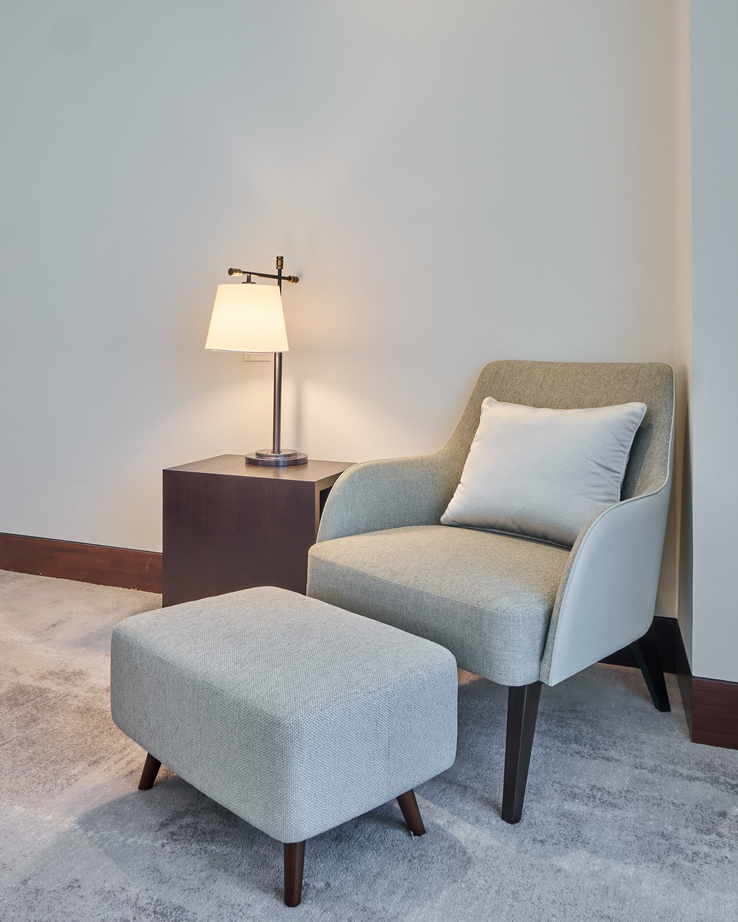 Cozy reading corner in luxury hotel suite in Downtown Dubai. Captured by interior photographer Oleg Novikov for property and Airbnb listings.