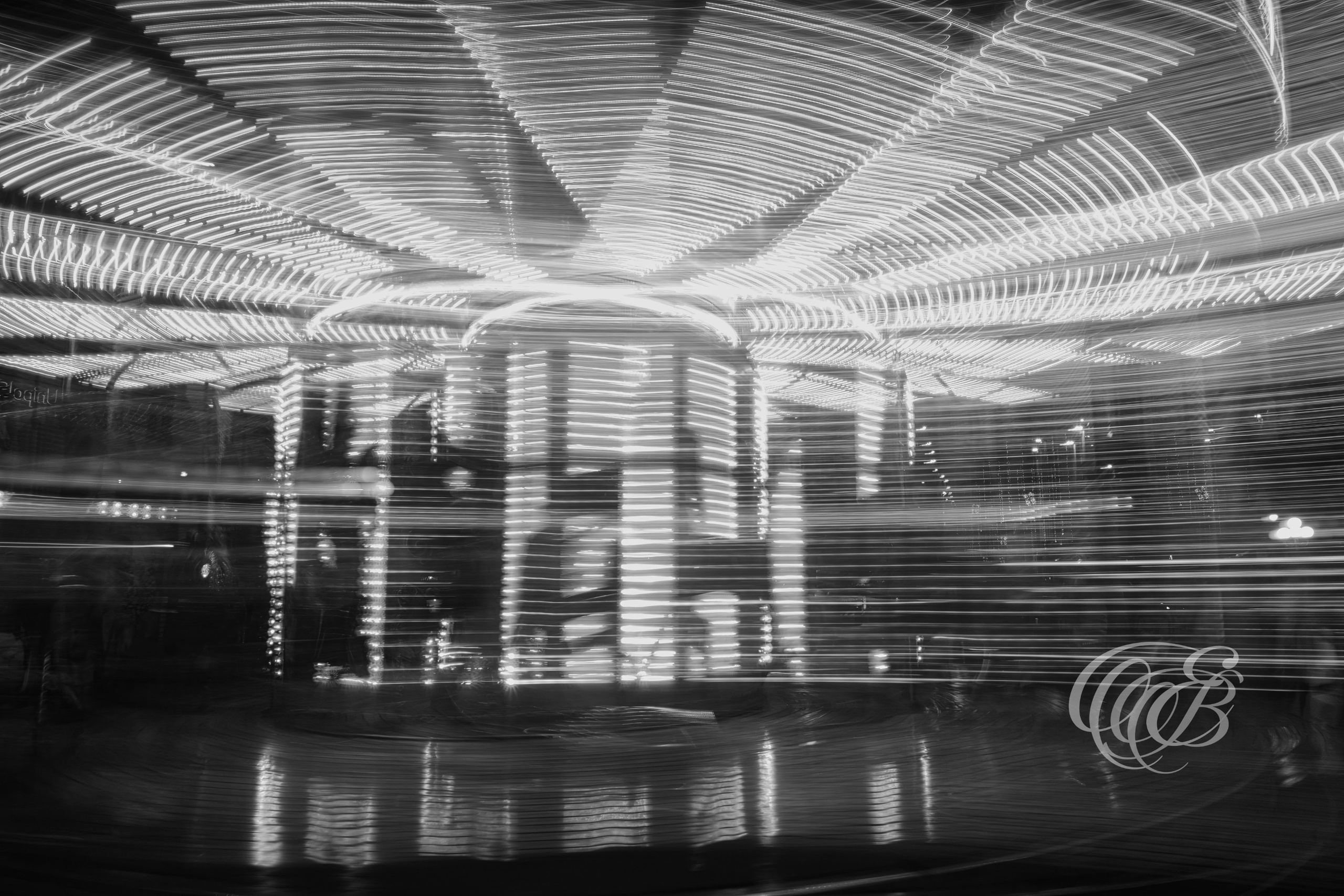 Florence Italy - Lights of a Moving Carousel - B&W - Eduardo Bartoli Fine Art Photography - Black-and-white photograph of the abstract lights of a moving carousel in Florence, Italy – fine art photography by Eduardo Bartoli.