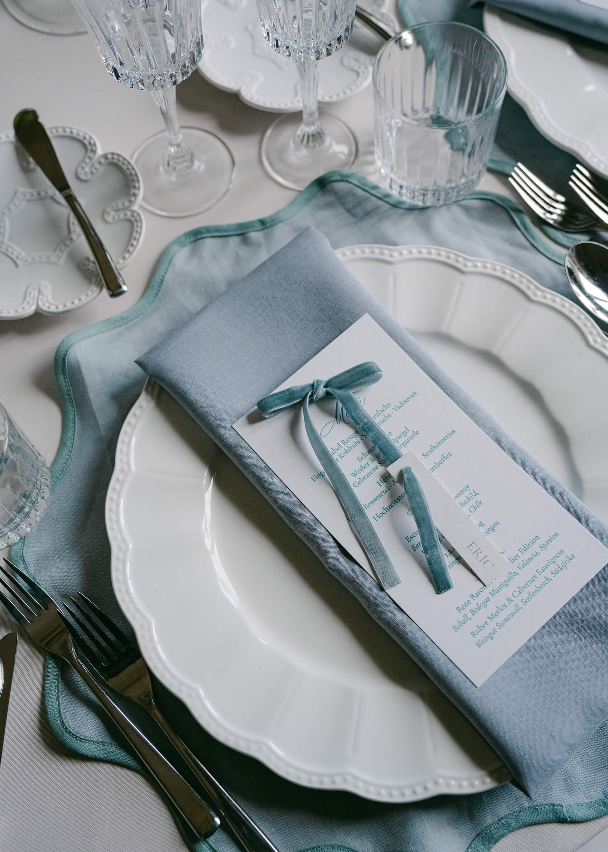 Luxury wedding place setting with blue napkin, wedding menu card and crystal glasses, Villa Rothschild Frankfurt