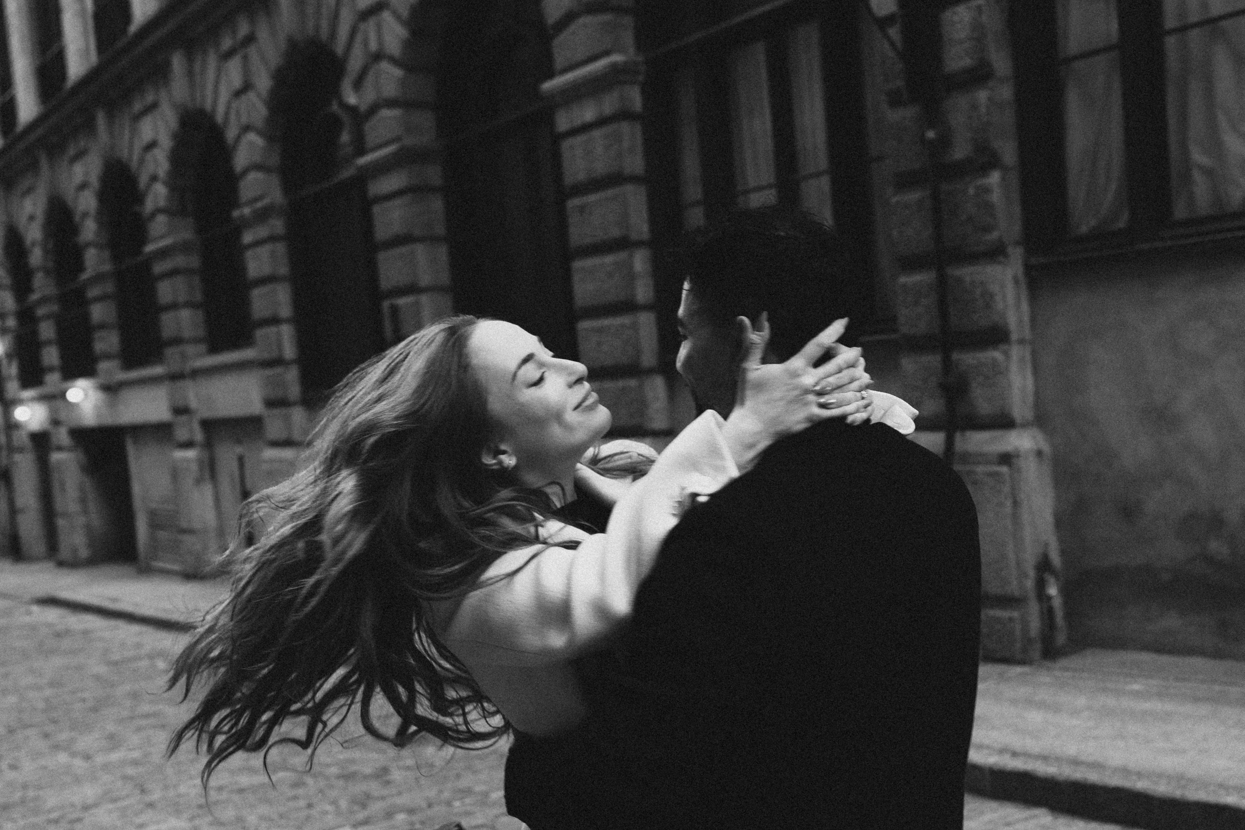 Romantic couple embracing on cobblestone street in Old Montreal