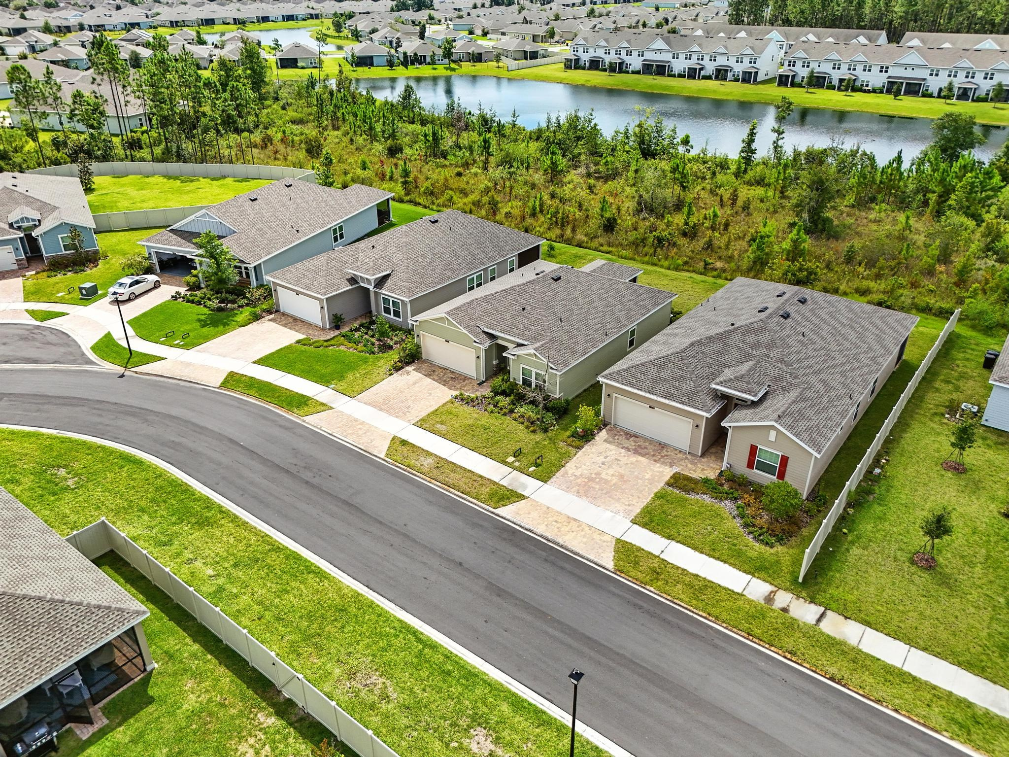 Suburban community street with houses and greenery