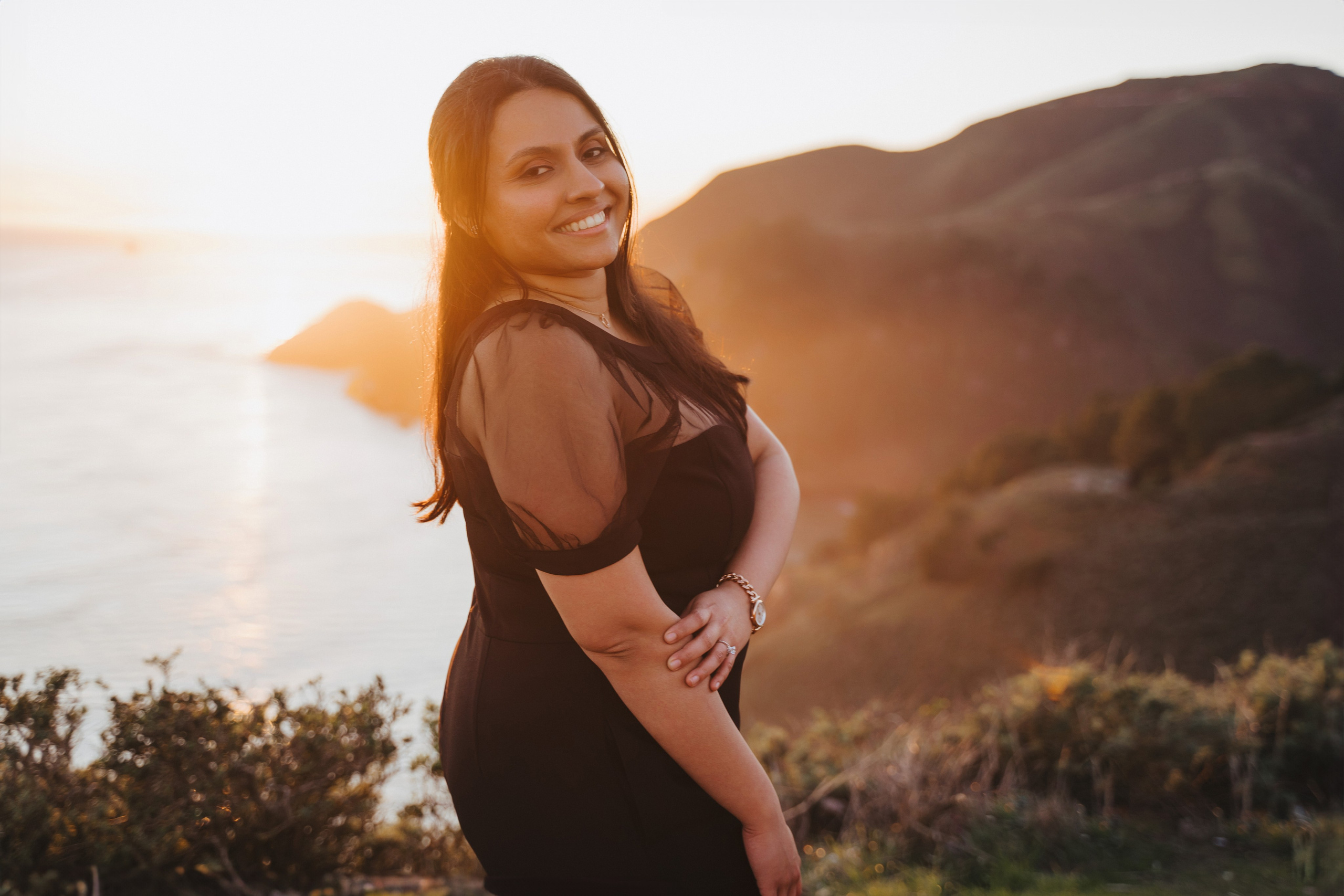 Proposal.  Overlooking the golden San Franisco Bridge sunset with a couple. Photographer Video. 