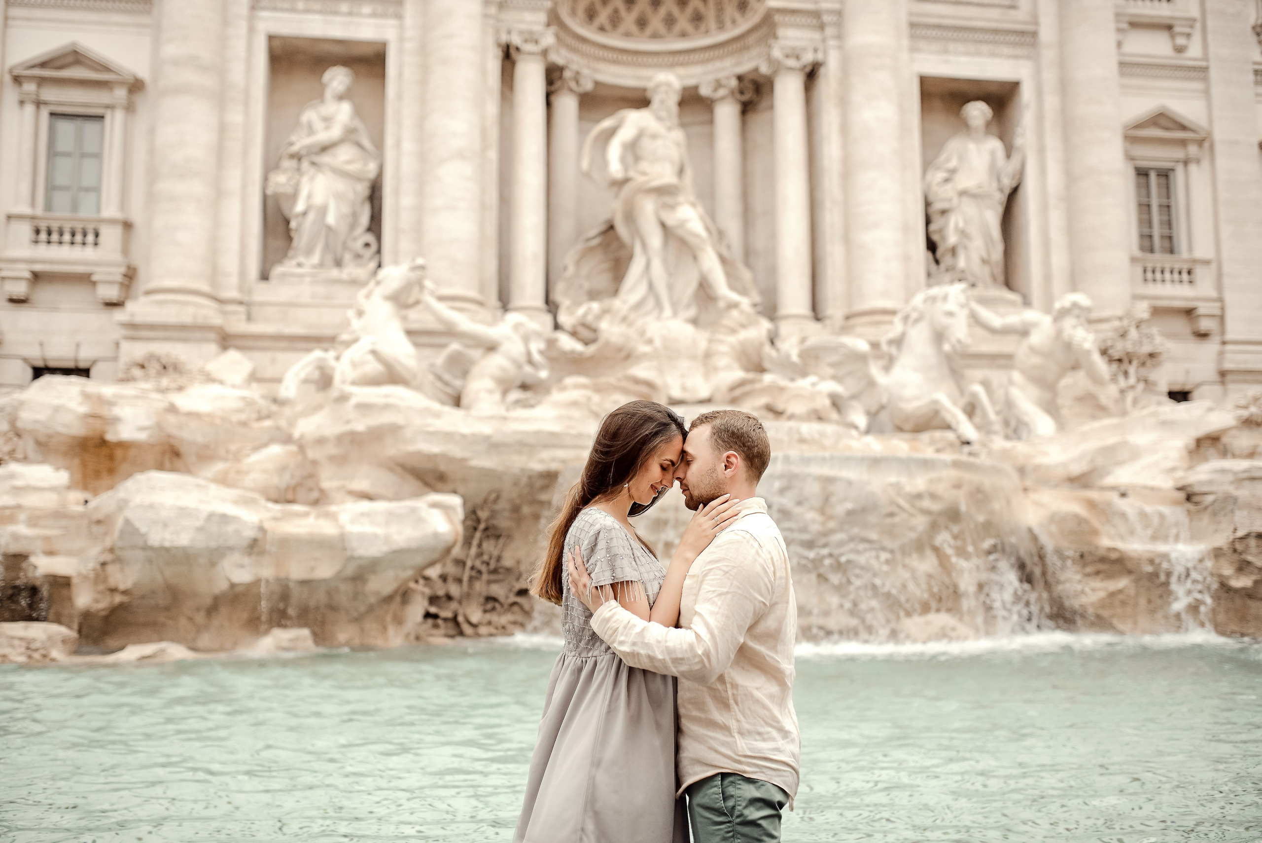 A couple sharing a quiet embrace by Trevi Fountain in the magic of Rome