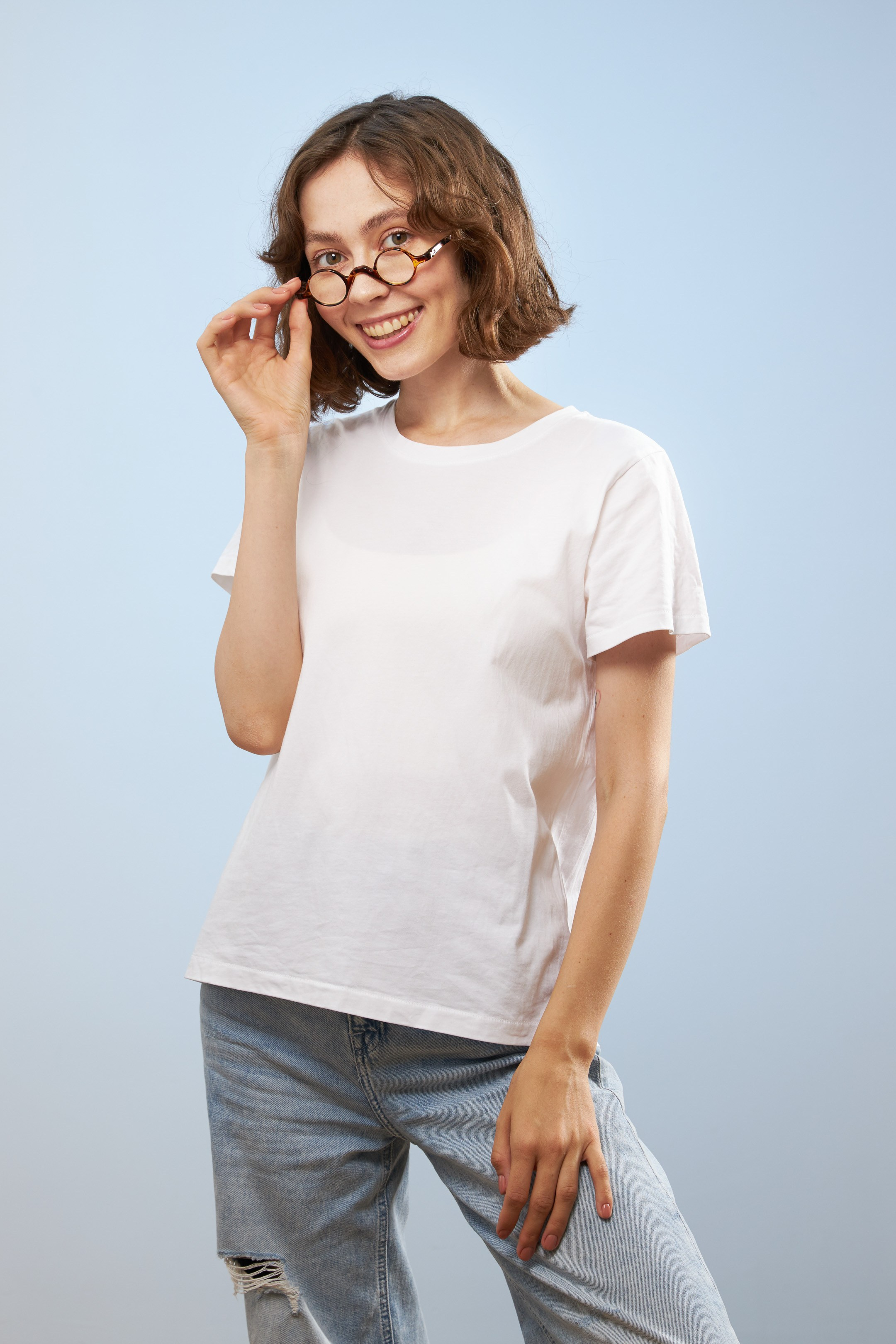 Eyewear model photoshoot - studio portrait of a young lady on light blue background - photographer Andrey Dunin