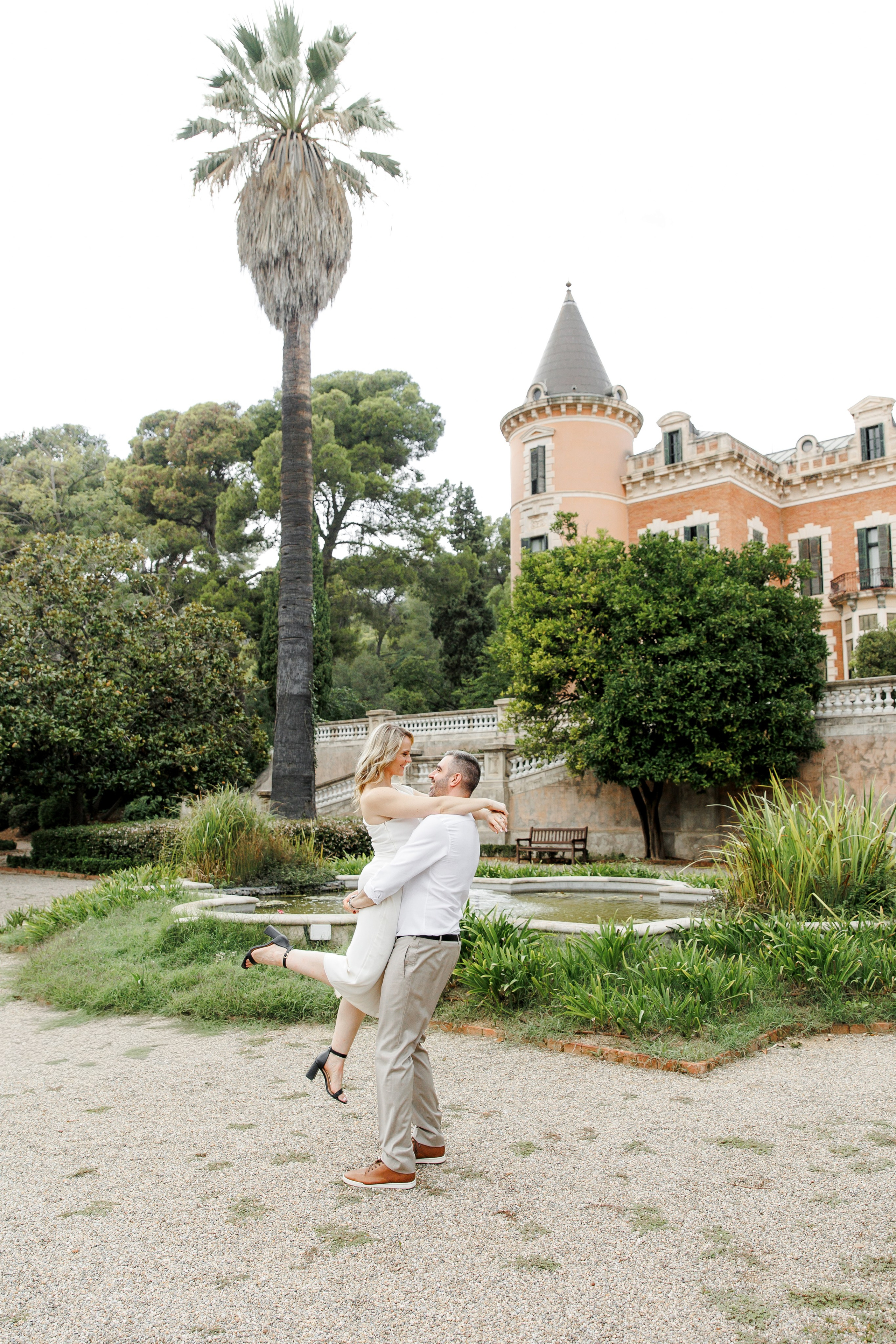 Bride and groom's portraits in front of the castle during their destination wedding in Barcelona 