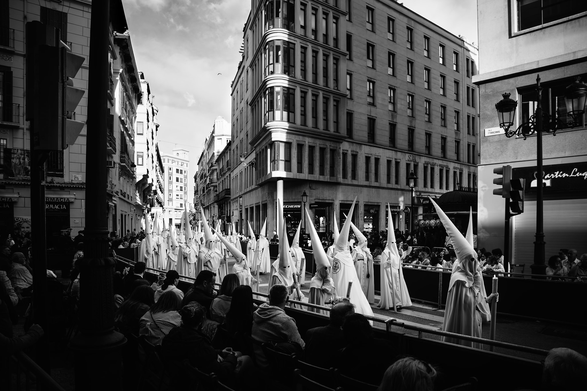 Crowd watching Semana Santa procession in historic center of Seville, Spain