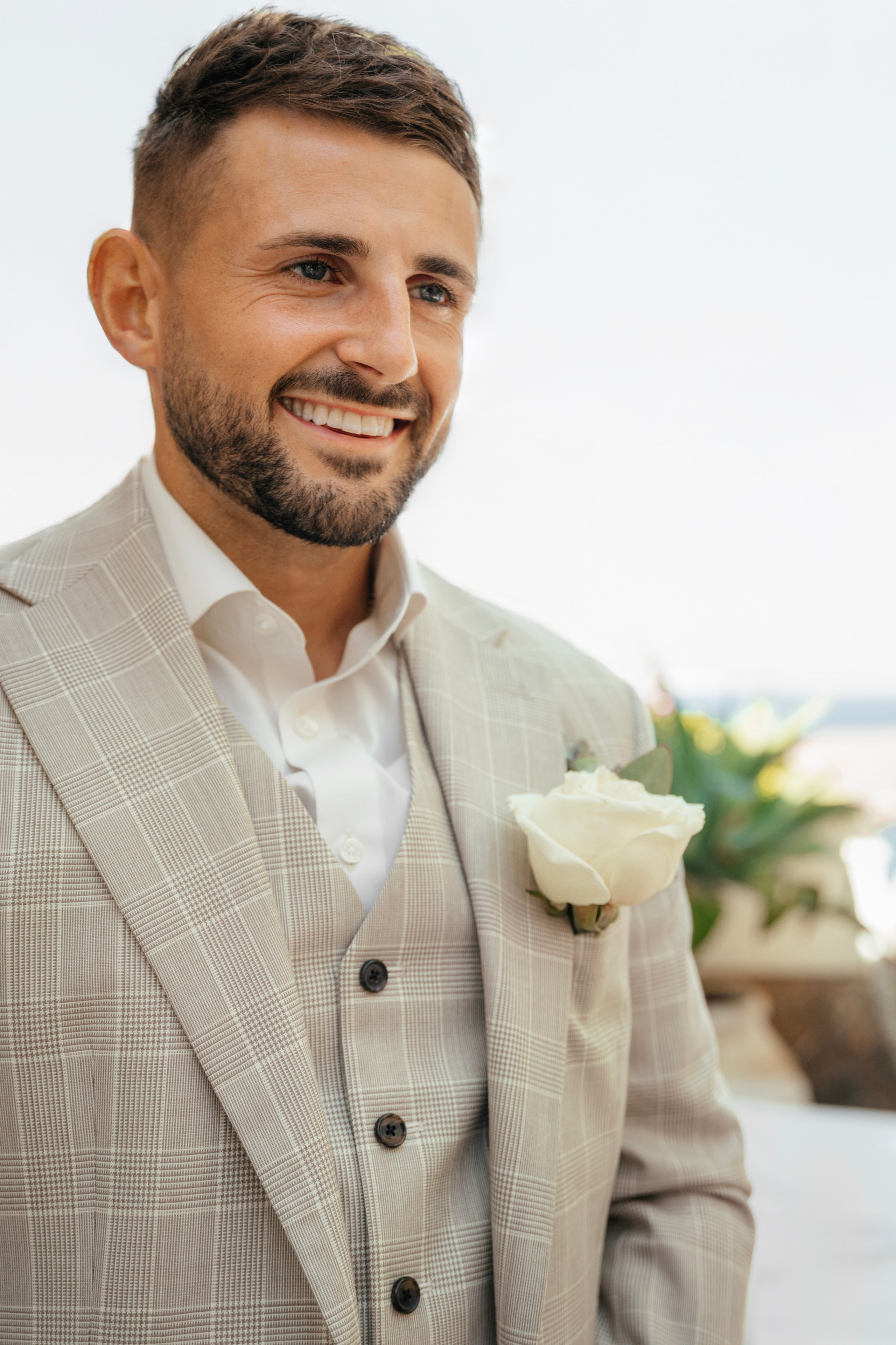 Groom smiling as he waits for his bride in Lindos, Rhodes, Greece