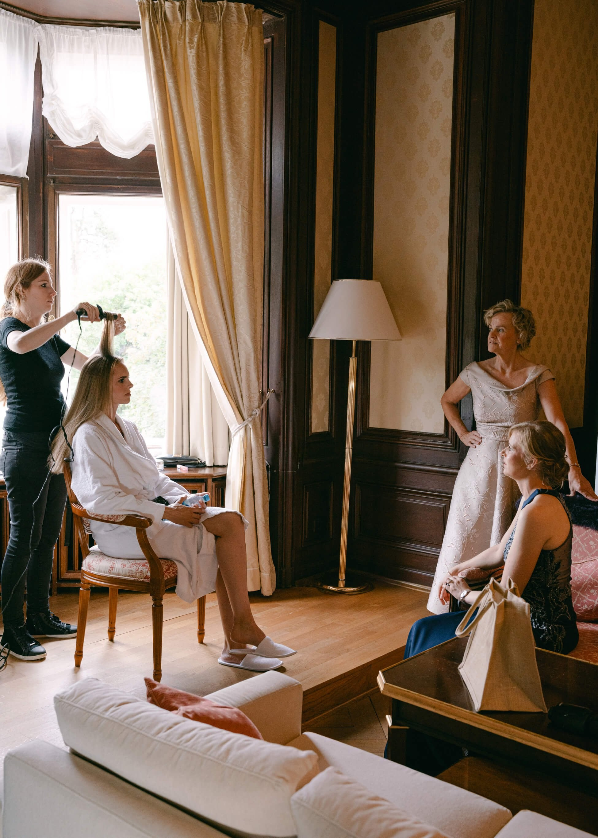 Bride having hair styled Rolex watches, getting ready at Villa Rothschild Frankfurt luxury wedding