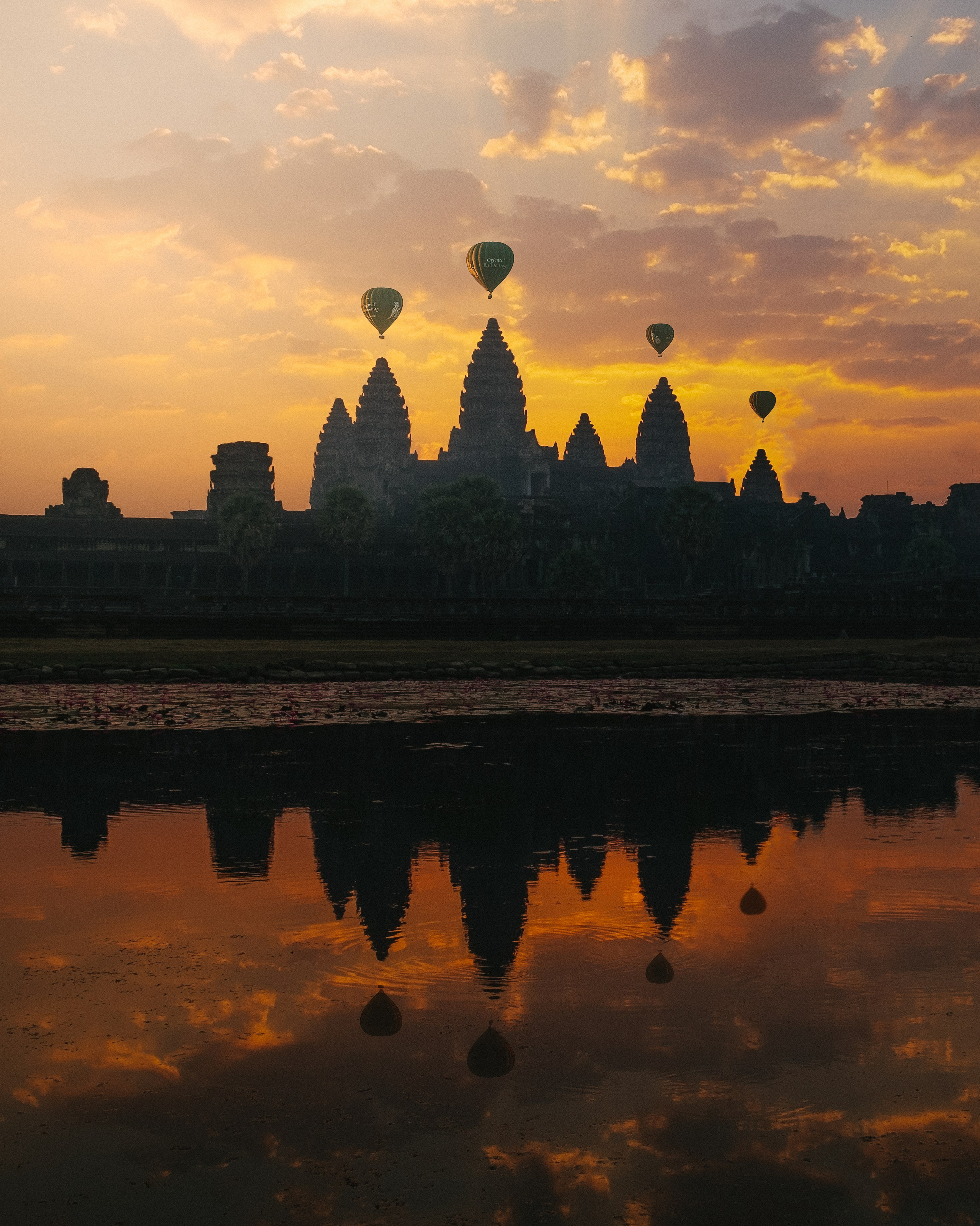 A photo of a famous landmark with hot air balloons in Indonesia during sunset 