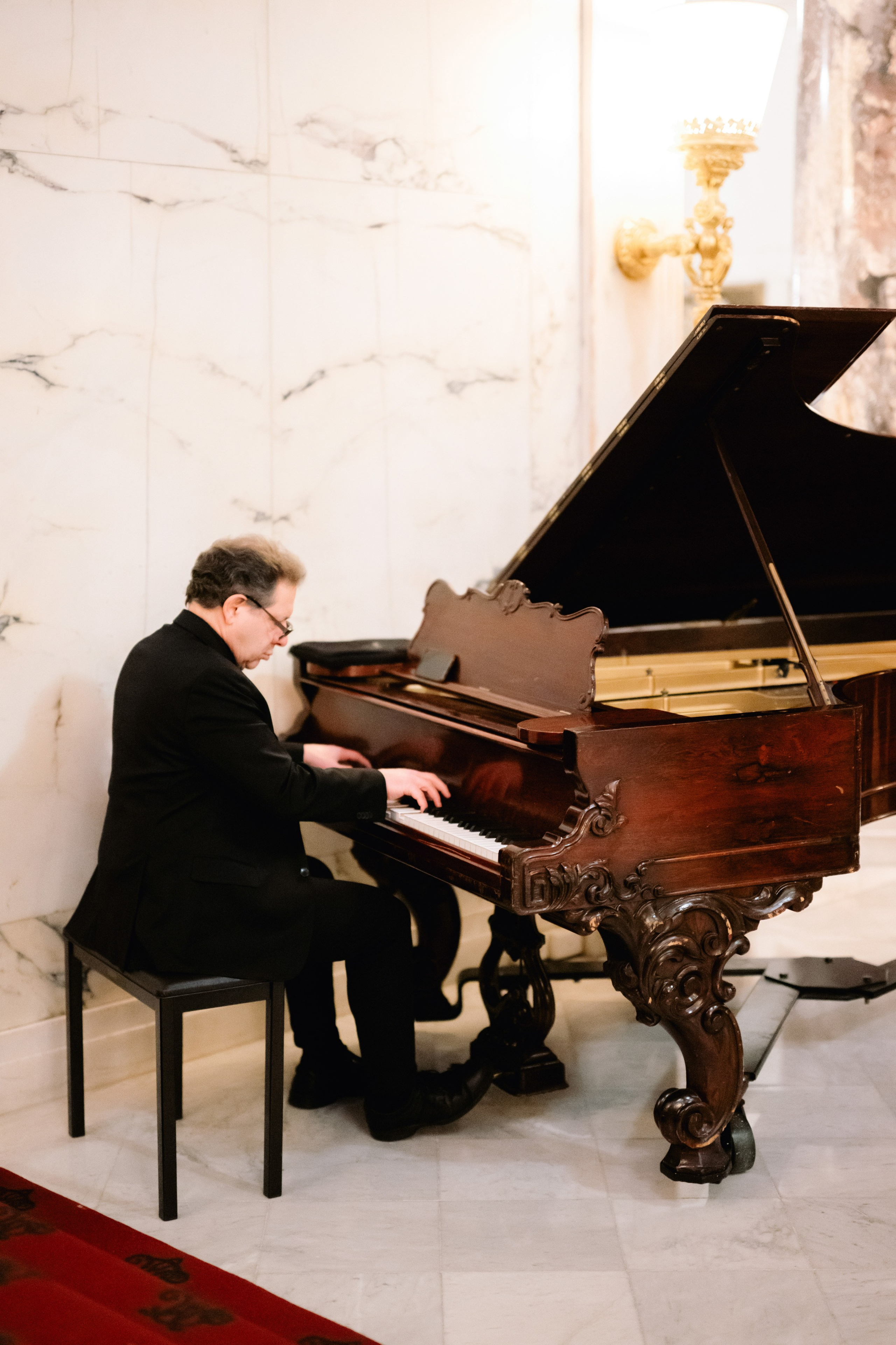 a man playing a grand piano