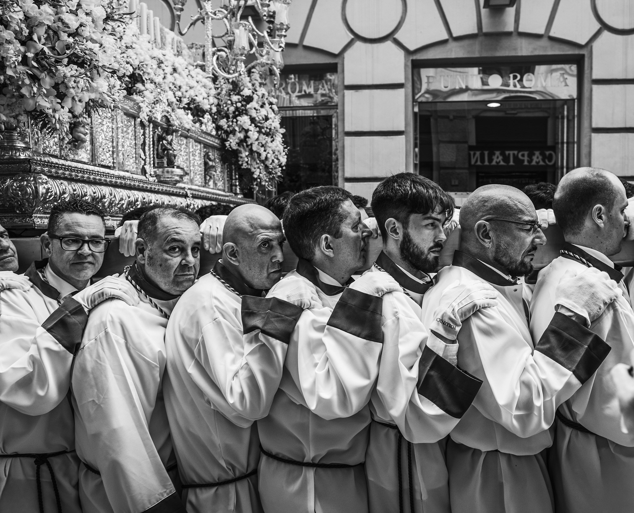Brotherhood members carrying paso during Semana Santa
