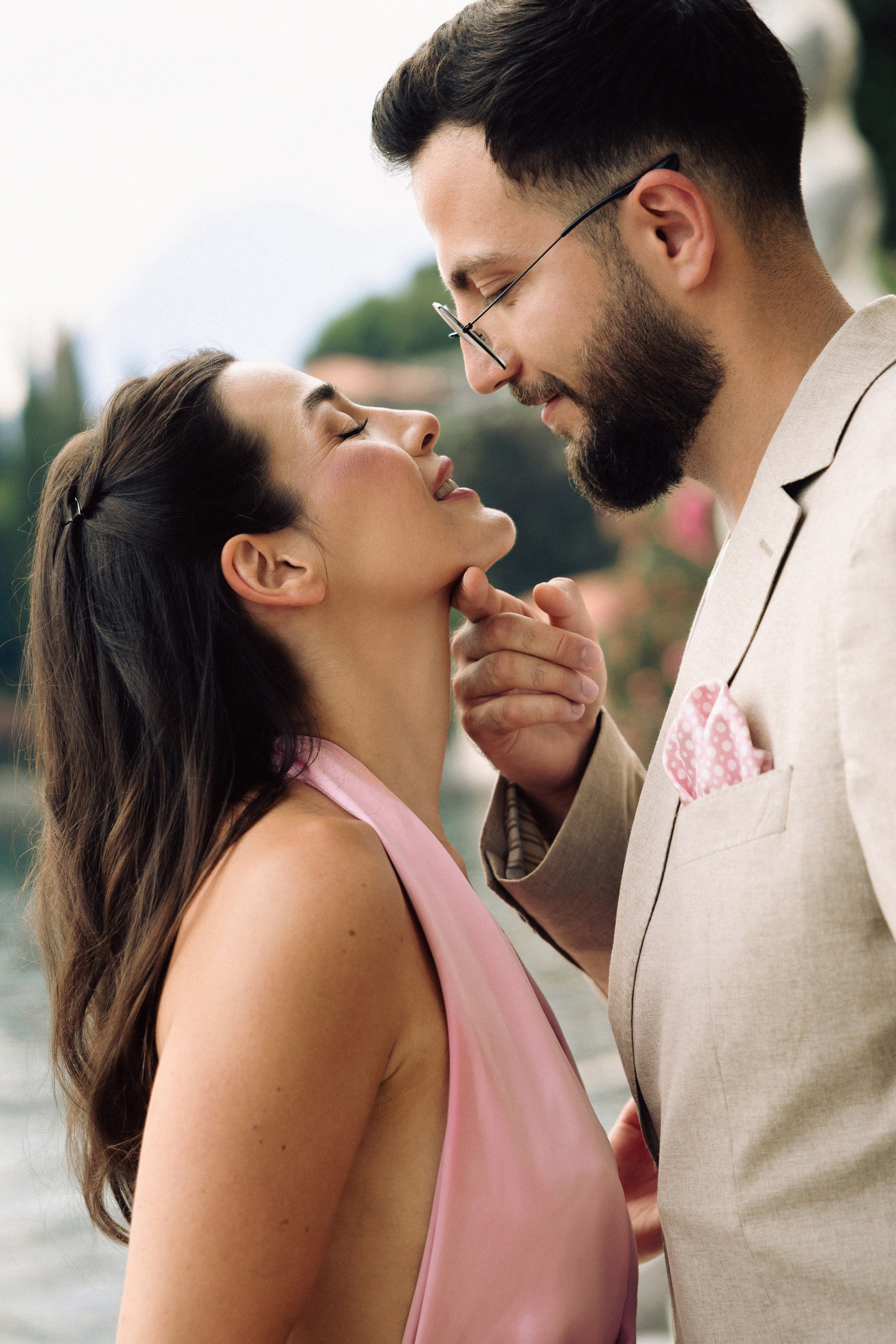 Couple embracing after a surprise engagement proposal on Lake Como