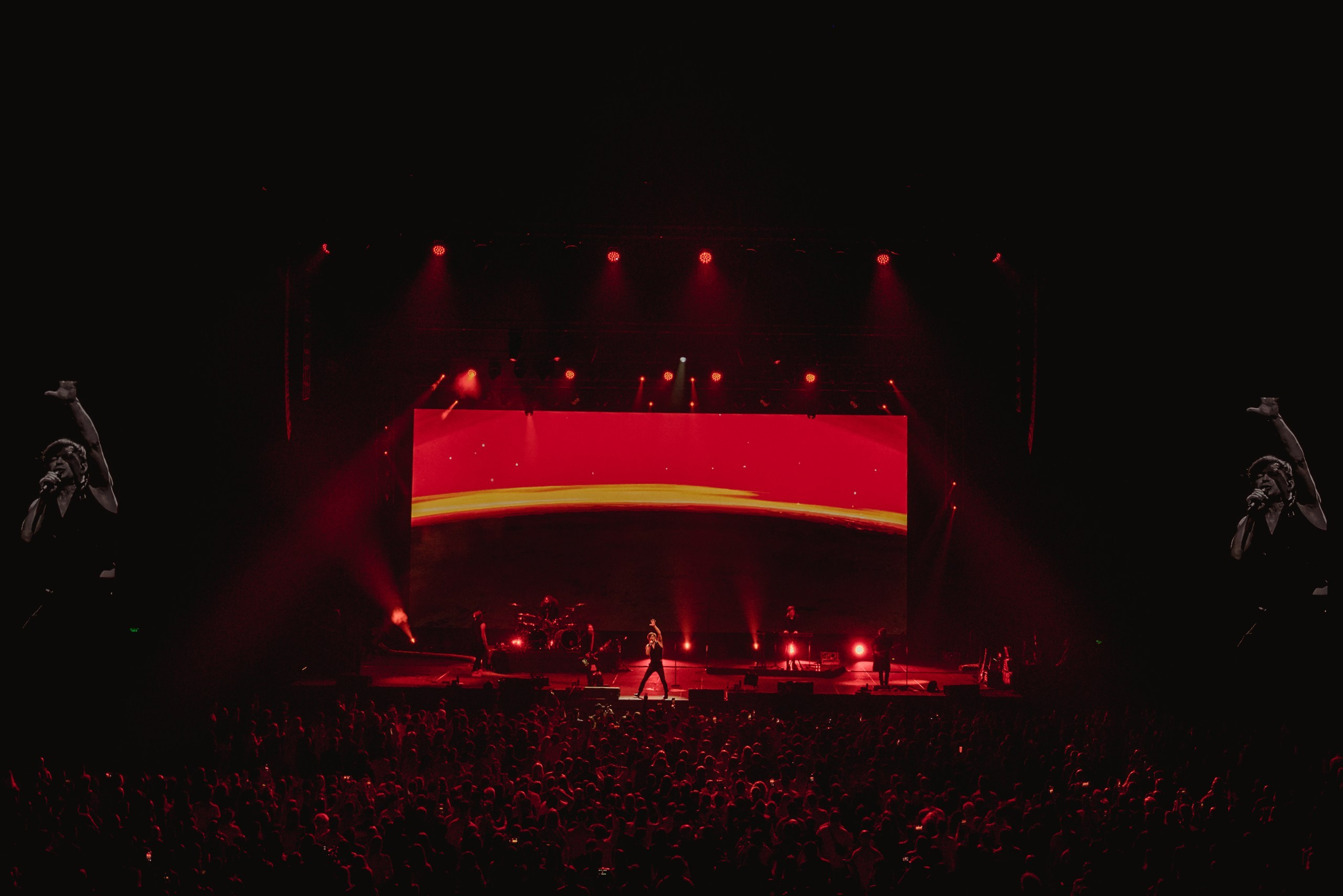 Crowd with hands in the air during a legendary DJ's headline set at a Dubai festival.