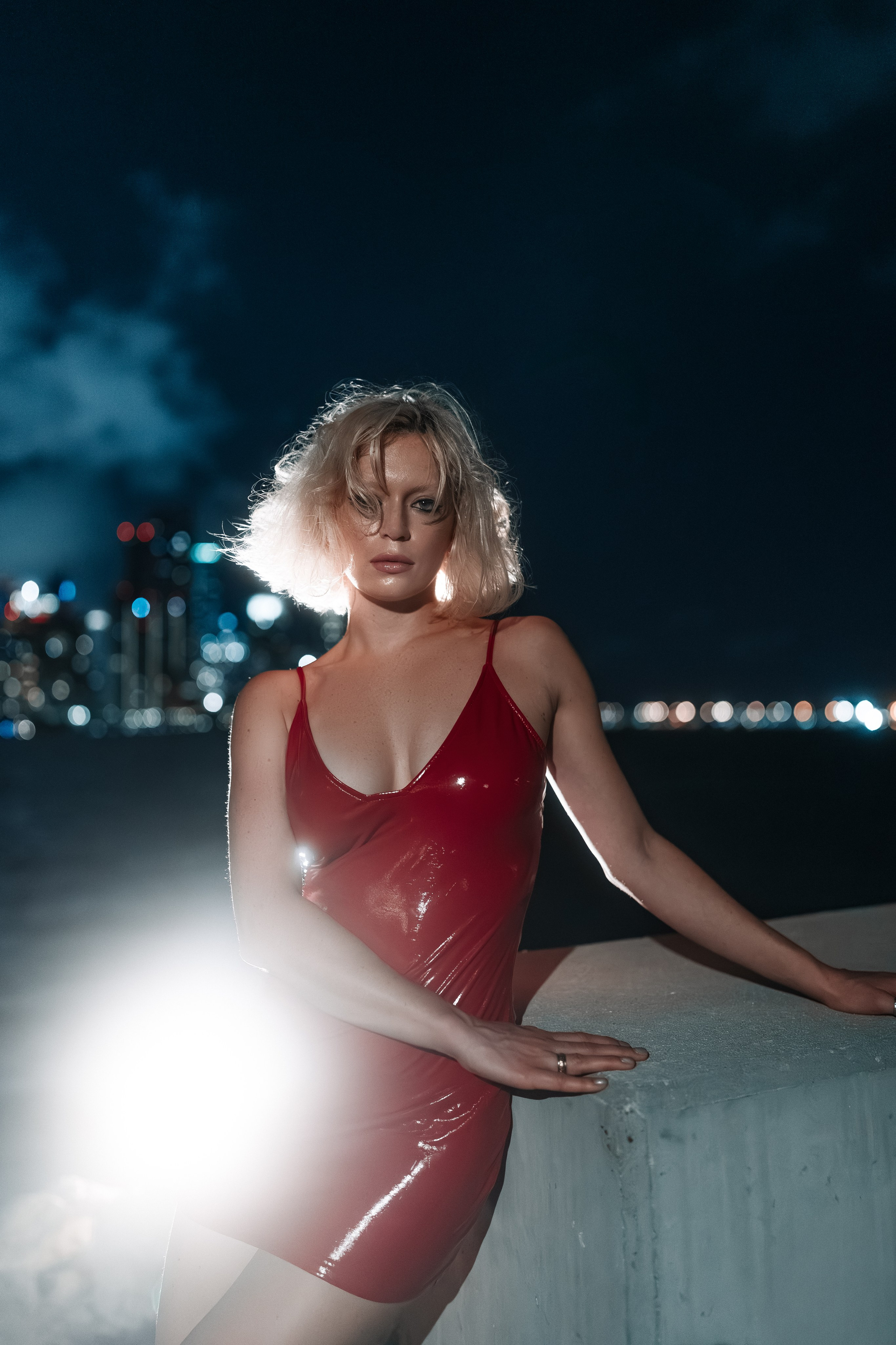 Confident standing pose with chin lifted slightly. The image conveys strength and calm together