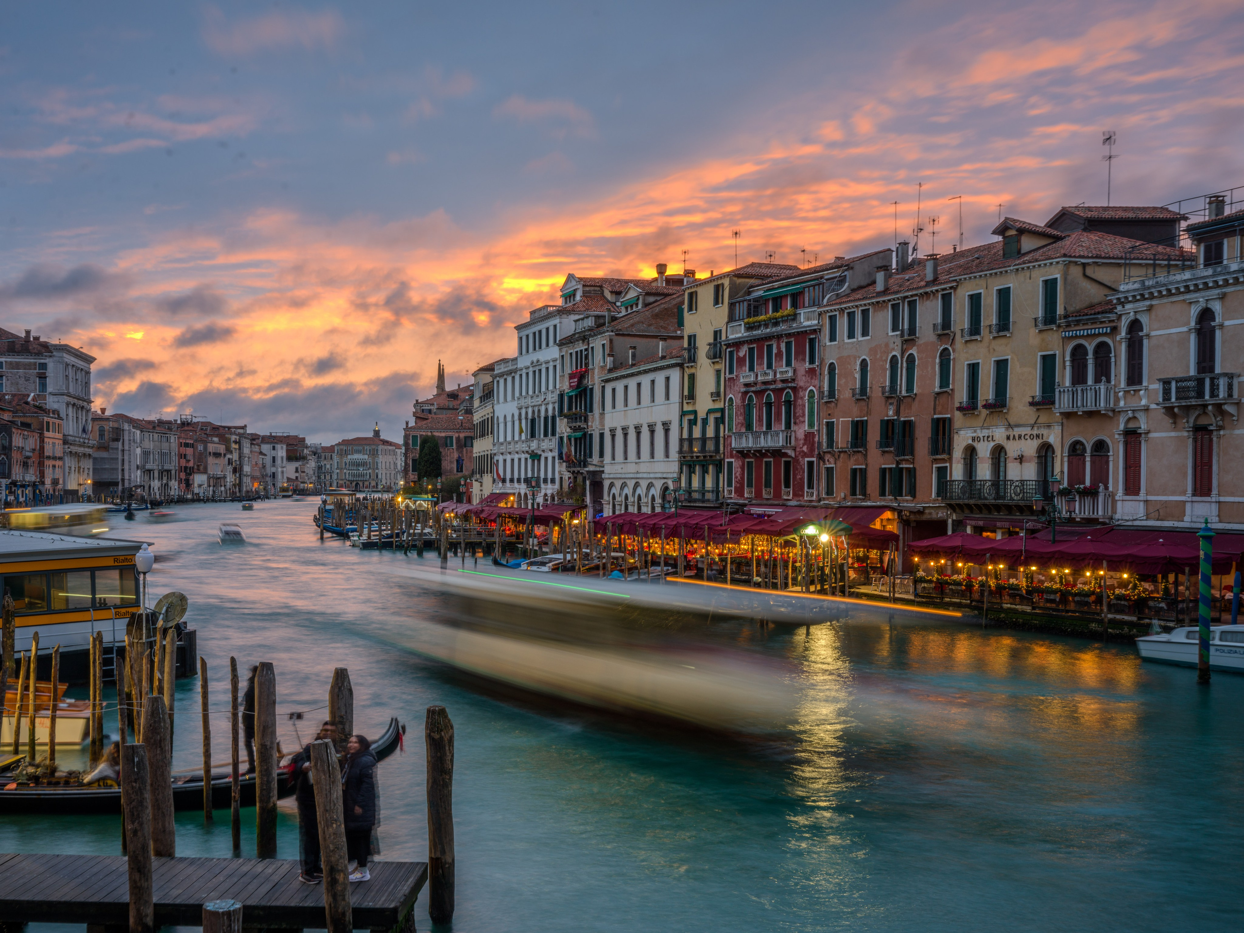 Grand Canal in Venice at sunset with motion blur boat and colorful sky