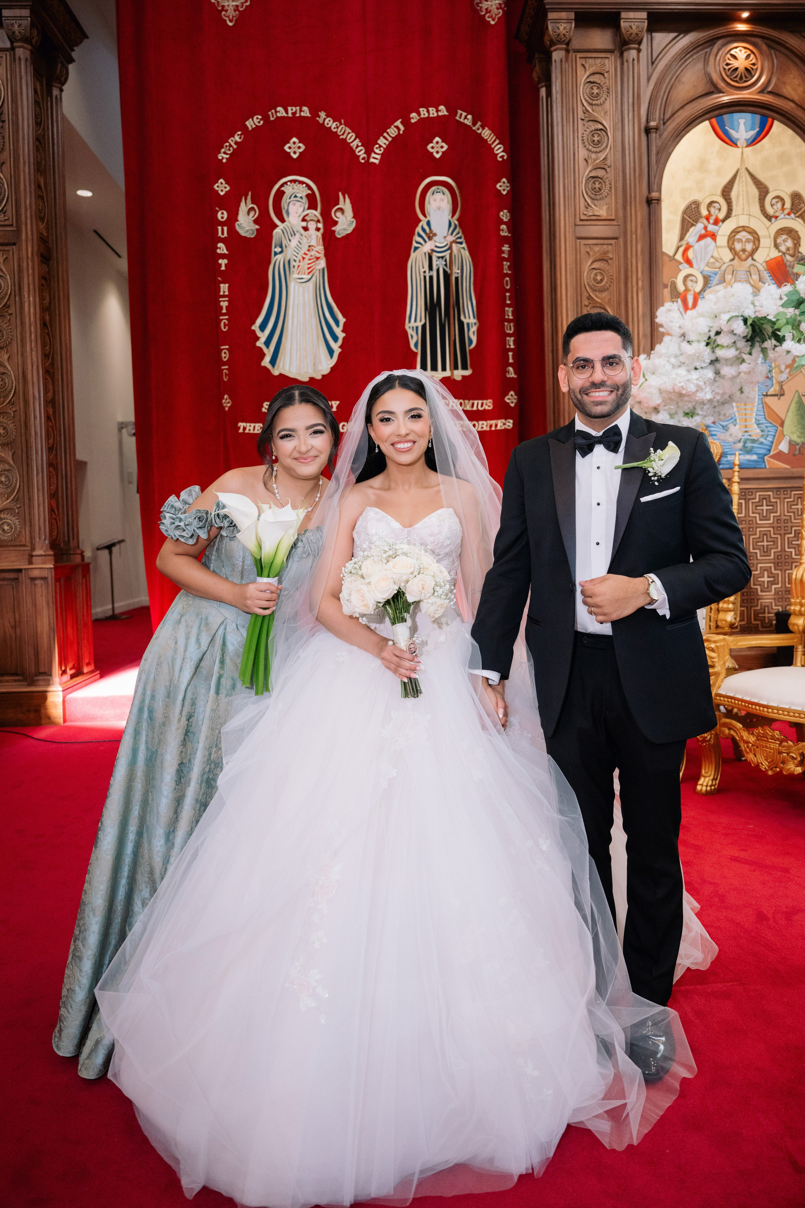 Couple standing together during a warm indoor reception moment