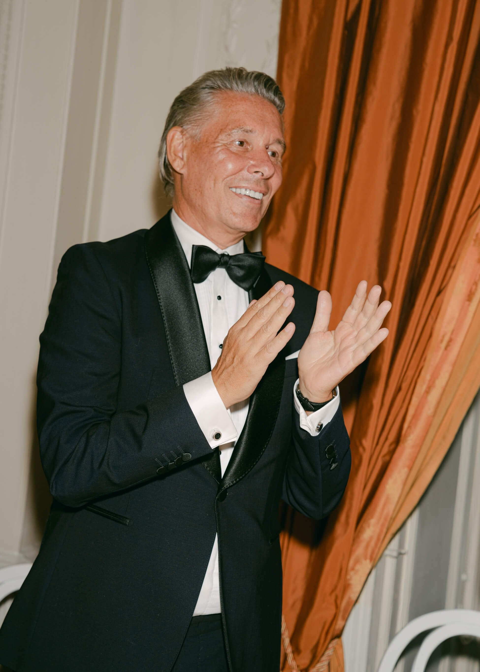 Wedding guest in black tuxedo at luxury wedding reception dinner, Villa Rothschild orange salon Frankfurt
