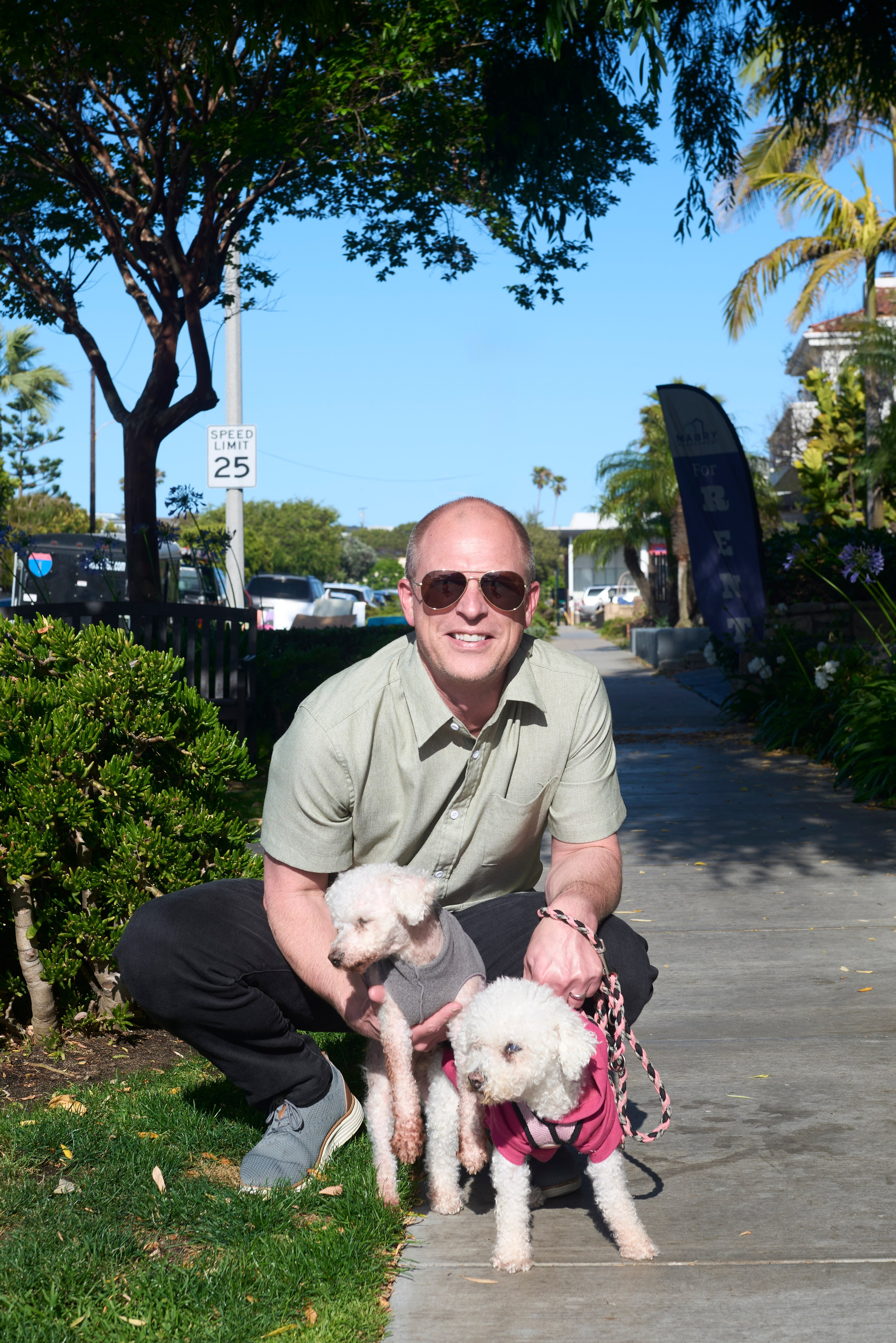 Emotional portrait of a couple with their dog walking along the beach in Torrance, California