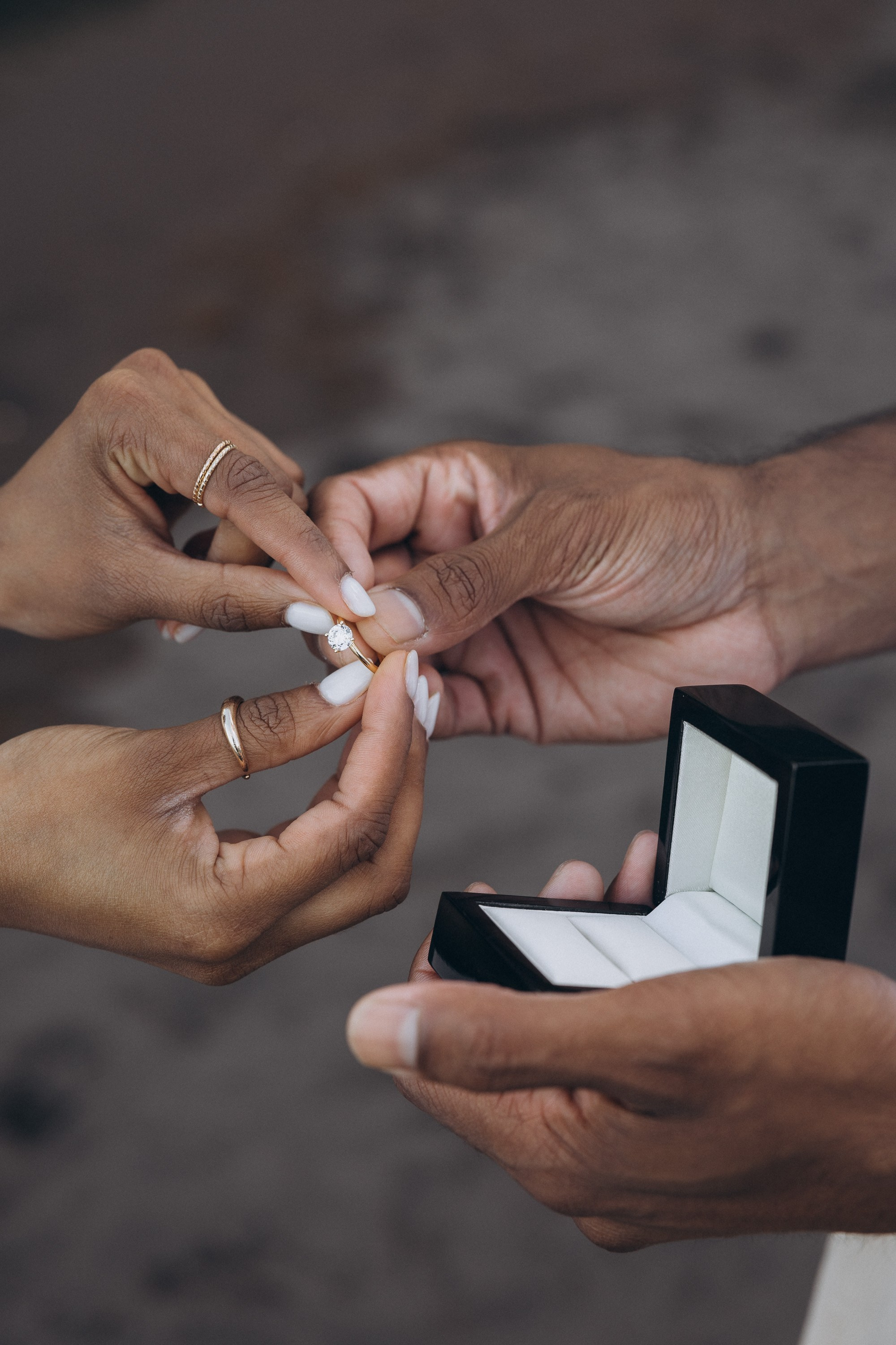 Romantic proposal on Seixal Beach, Madeira — black sand and ocean waves.