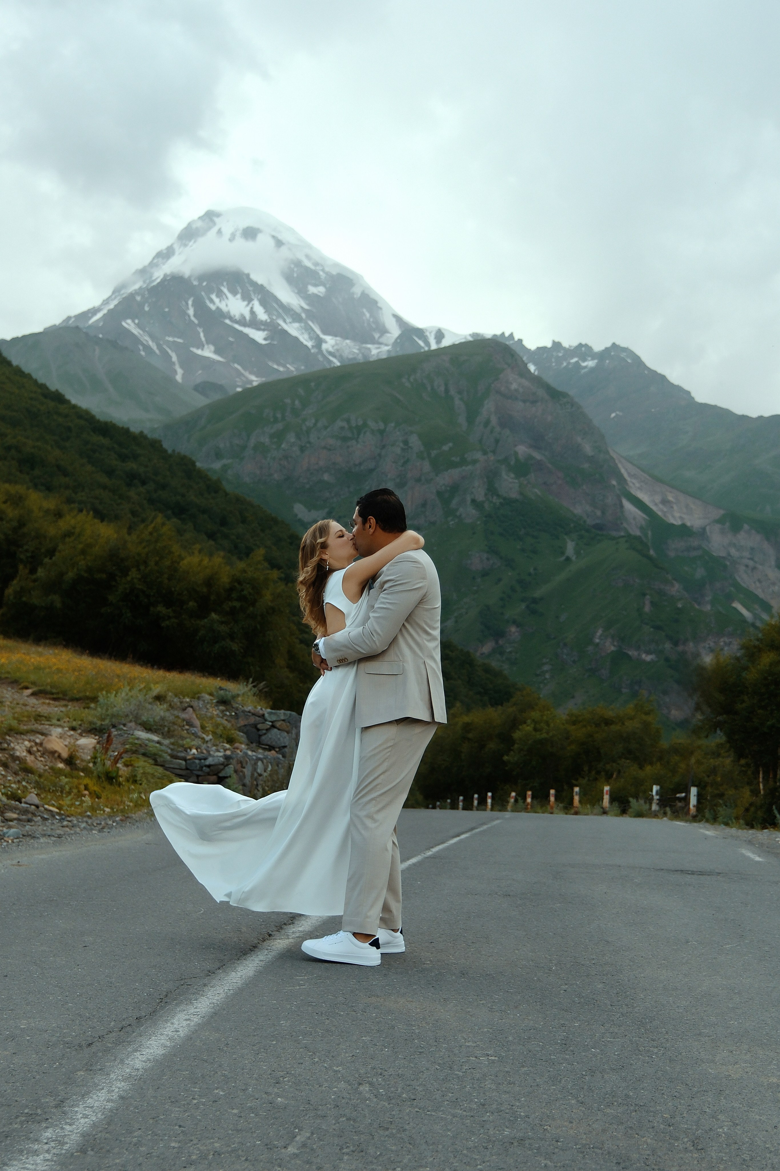 Couple dancing at the Gergeti Trinity Church,  Kazbegi
