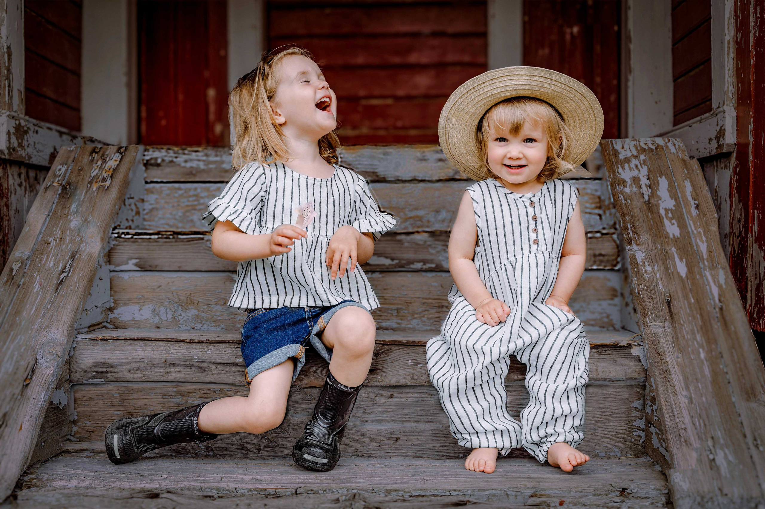 Girls sitting on wooden porch at a countryside farm – natural lifestyle photo