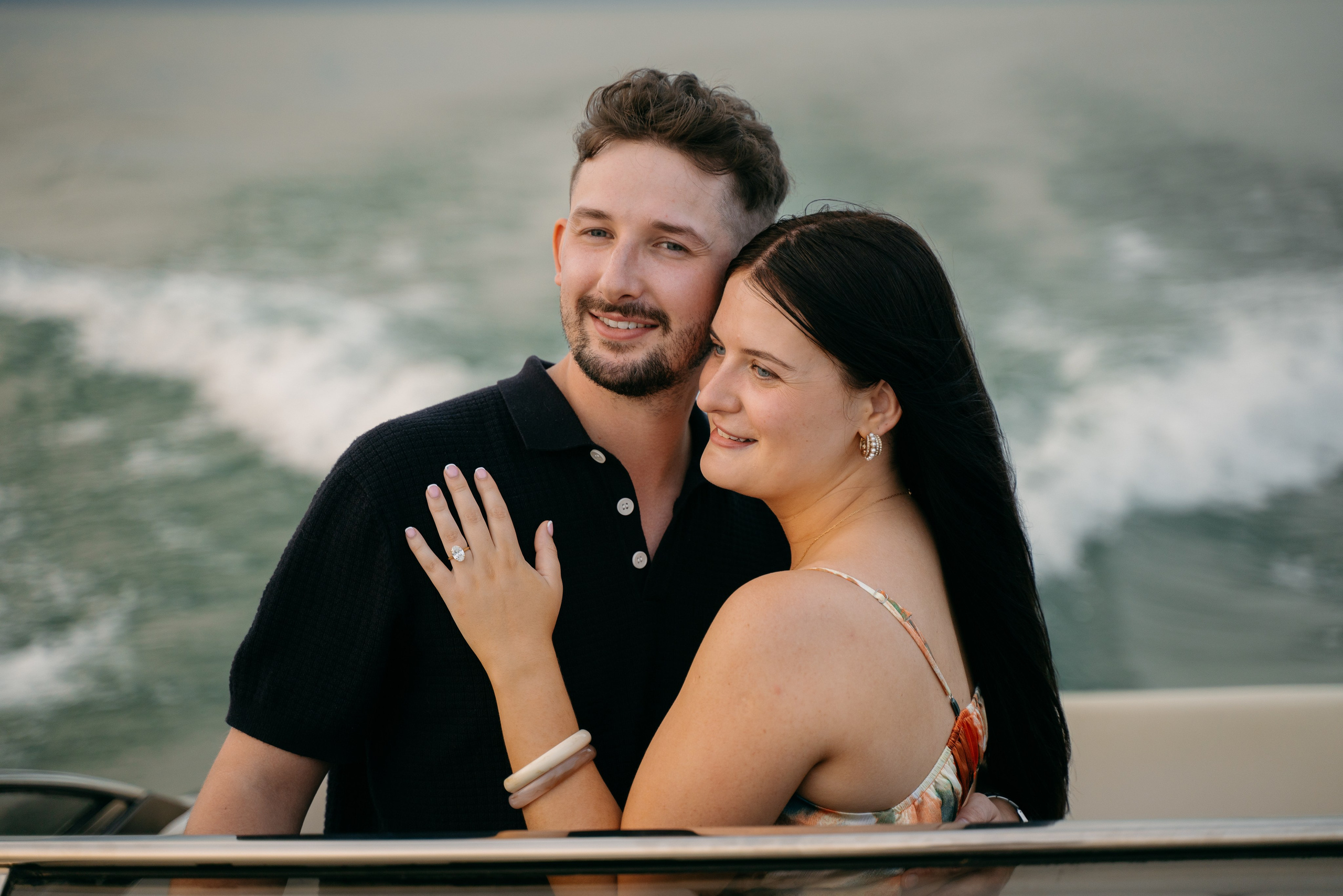 Natural engagement portrait captured while sailing along the Sirmione peninsula on Lake Garda.