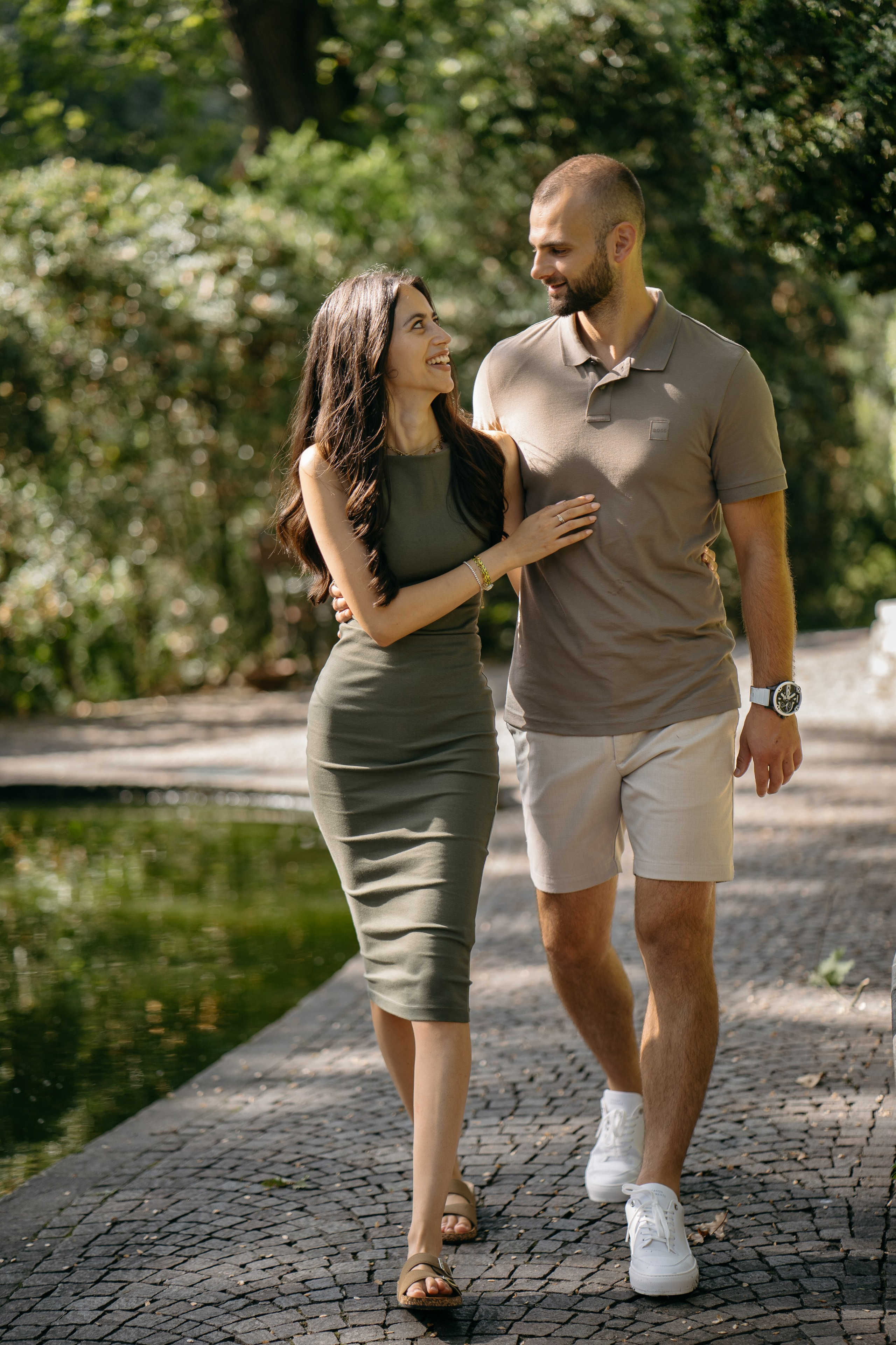 Couple walking hand in hand through Parco Giardino Sigurtà after their marriage proposal.